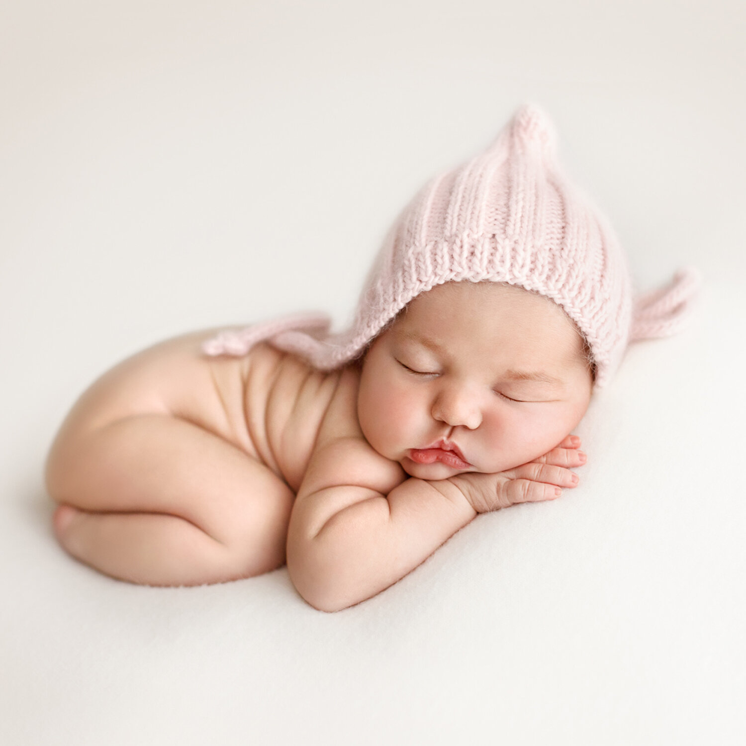 newborn-baby-girl-pink-hat-nude.jpg