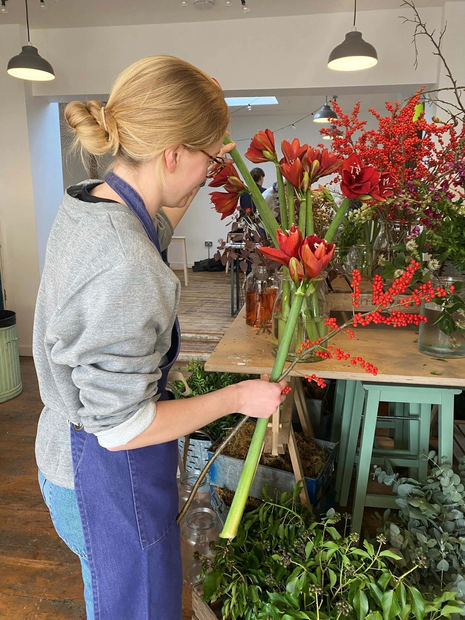 A Bath Flower School student selecting seasonal blooms from an abundant flower display (Copy)