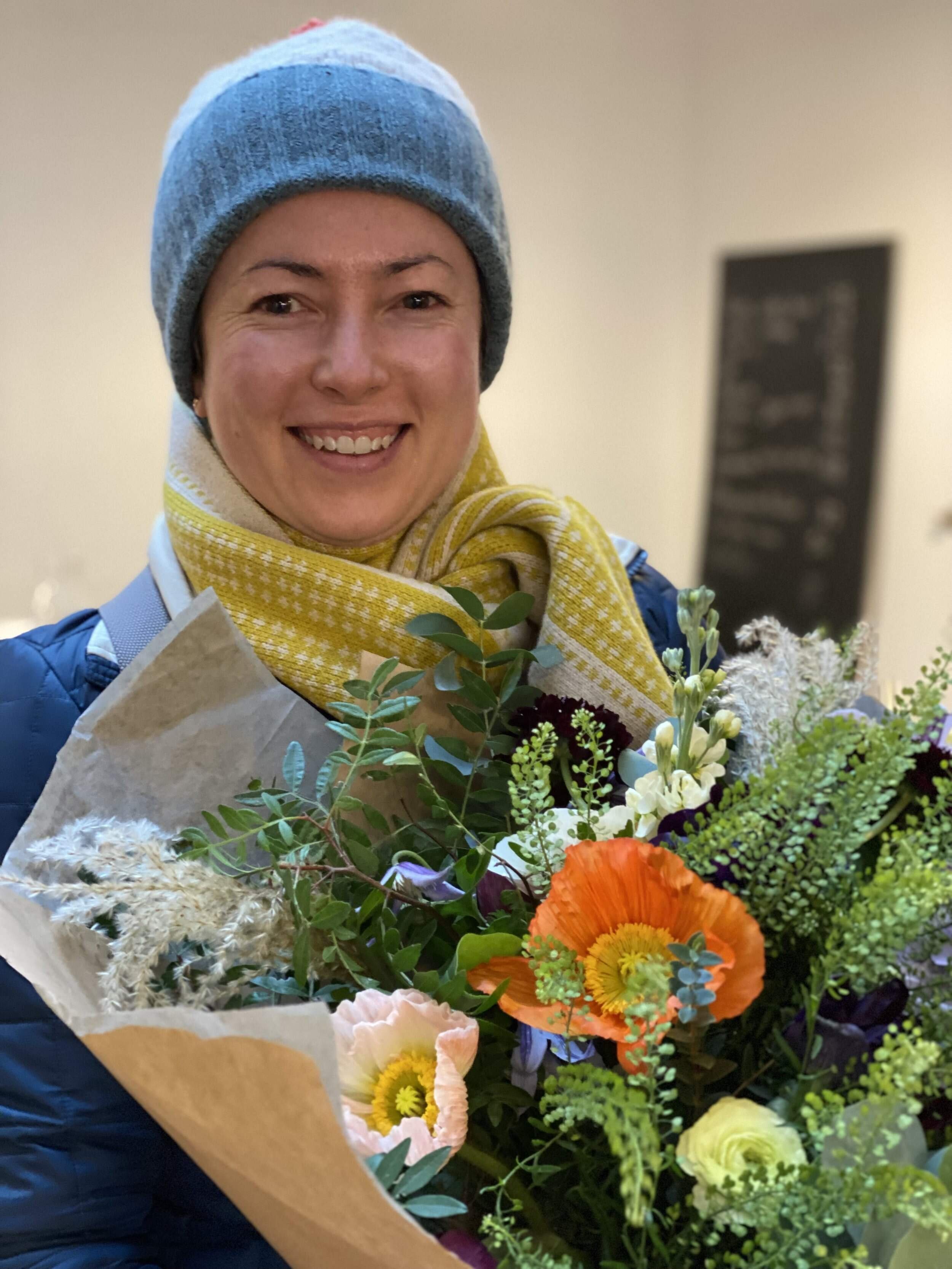 Happy student holding her bouquet with Icelandic poppes