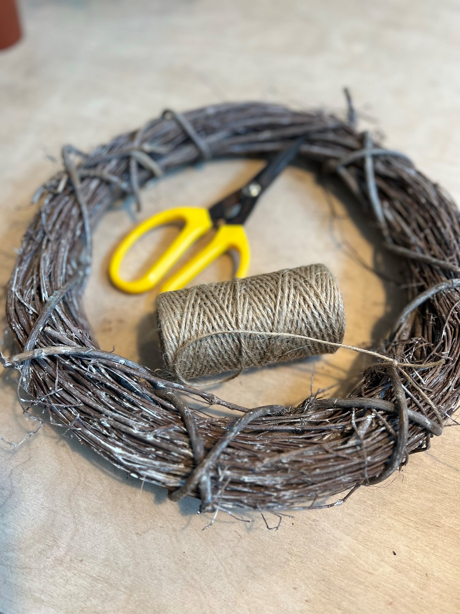 Natural wreath with string and yellow scissors