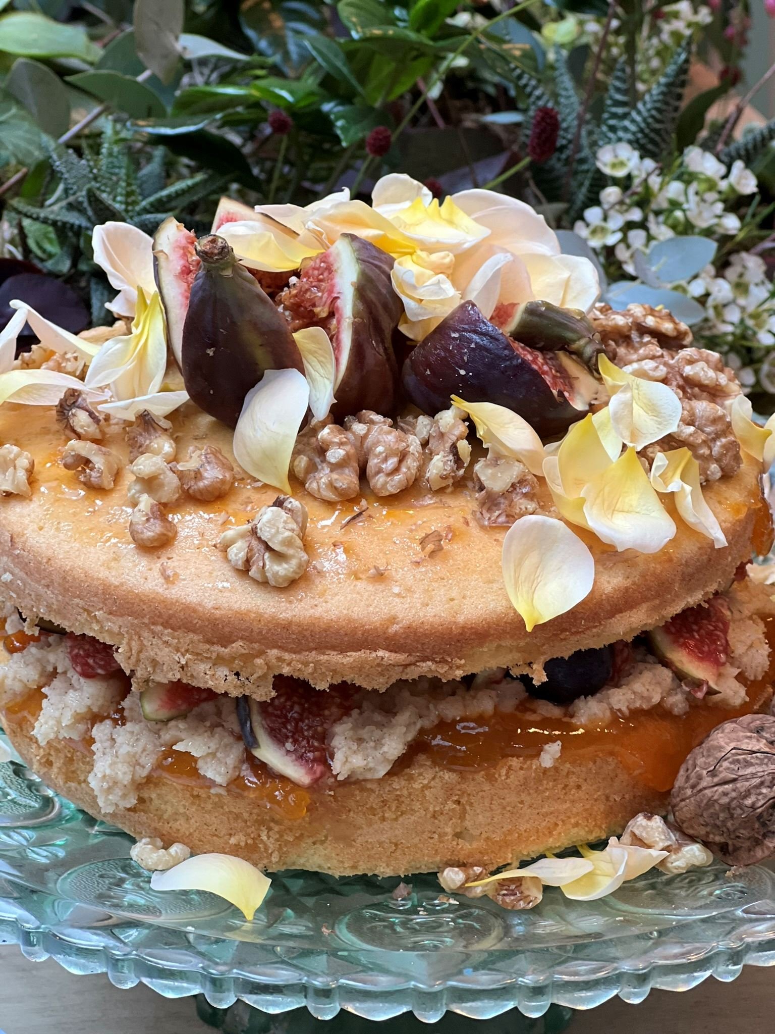 Autumnal cake decorated with figs and rose petals