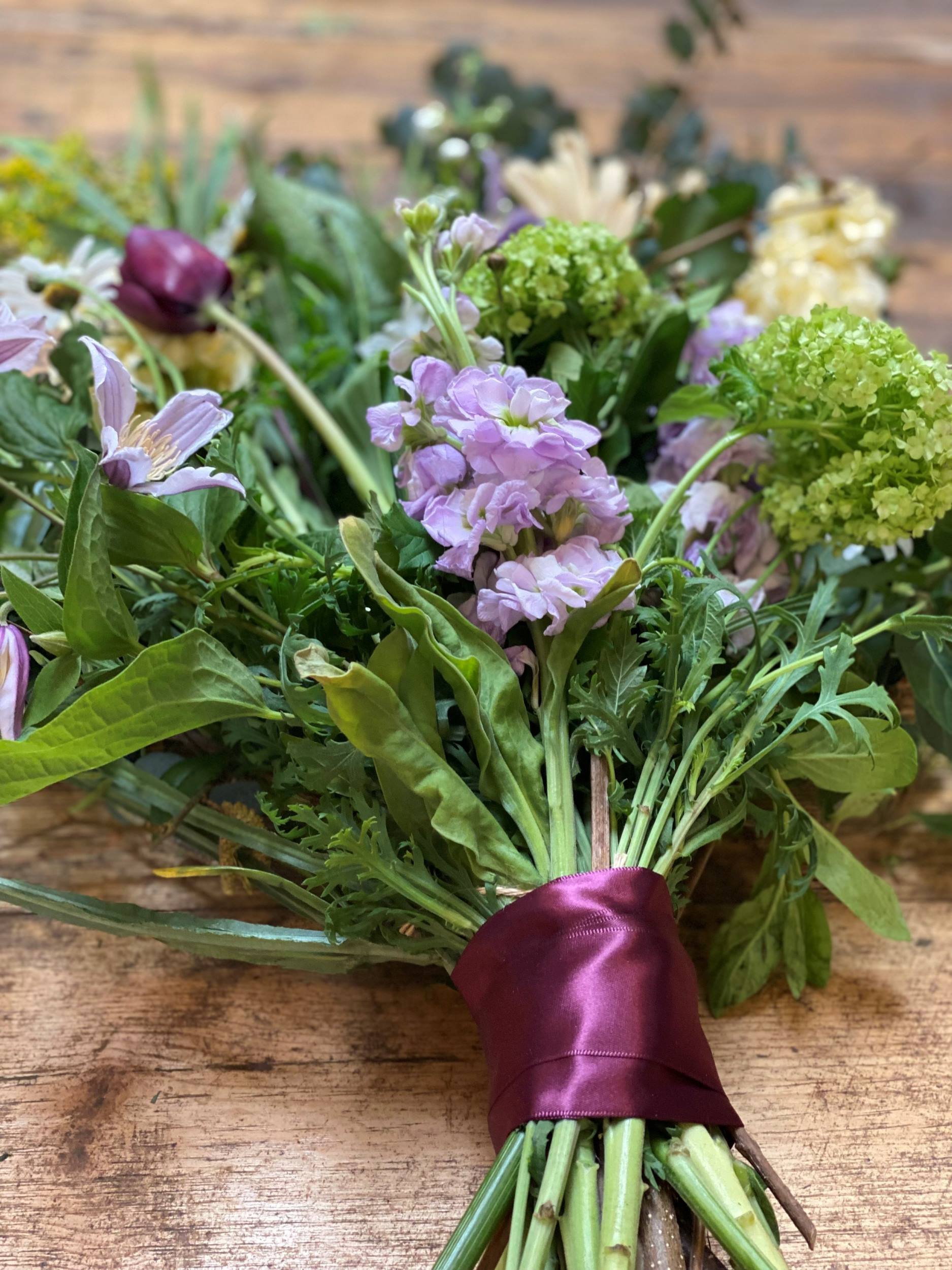 Naturally styled funeral sheaf with spring flowers