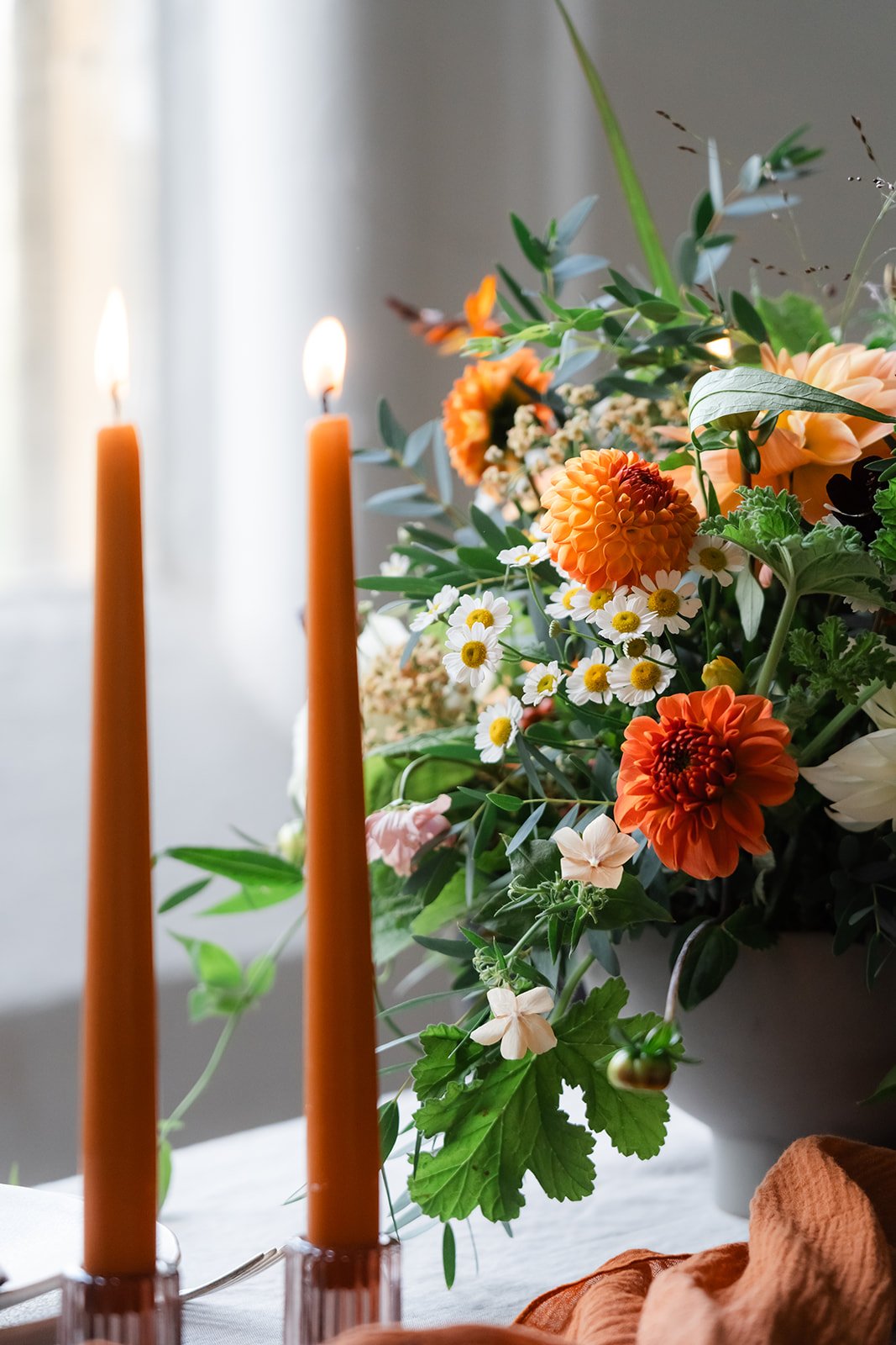 Sustainable table centre displayed with burnt orange candles