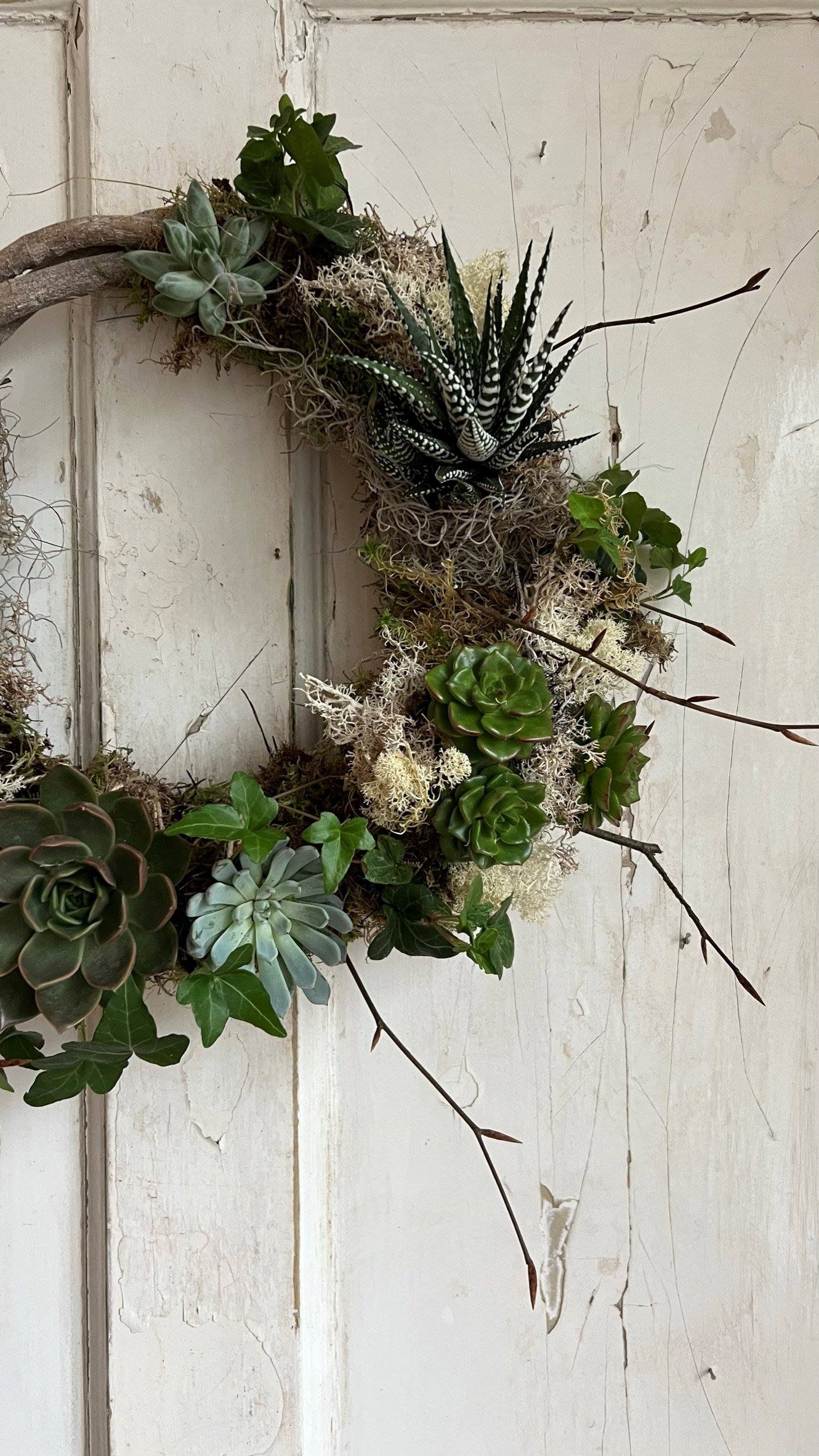 Sustainable living wreath on a wooden white door