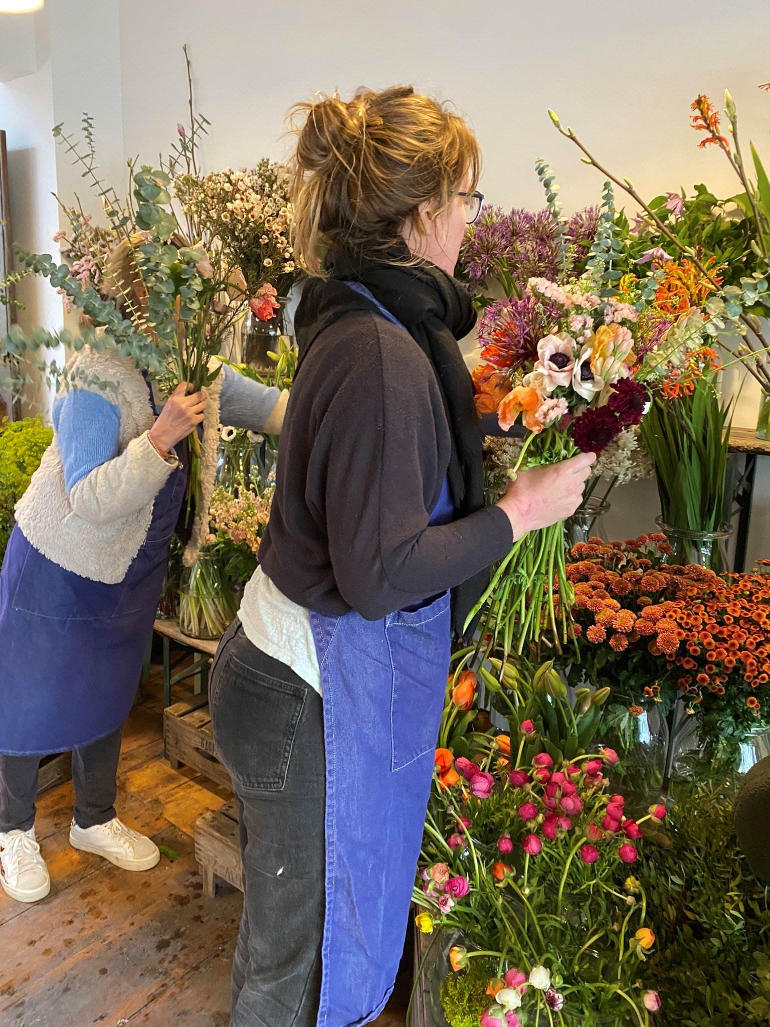 Professional floristry students selecting flowers from the flower stand