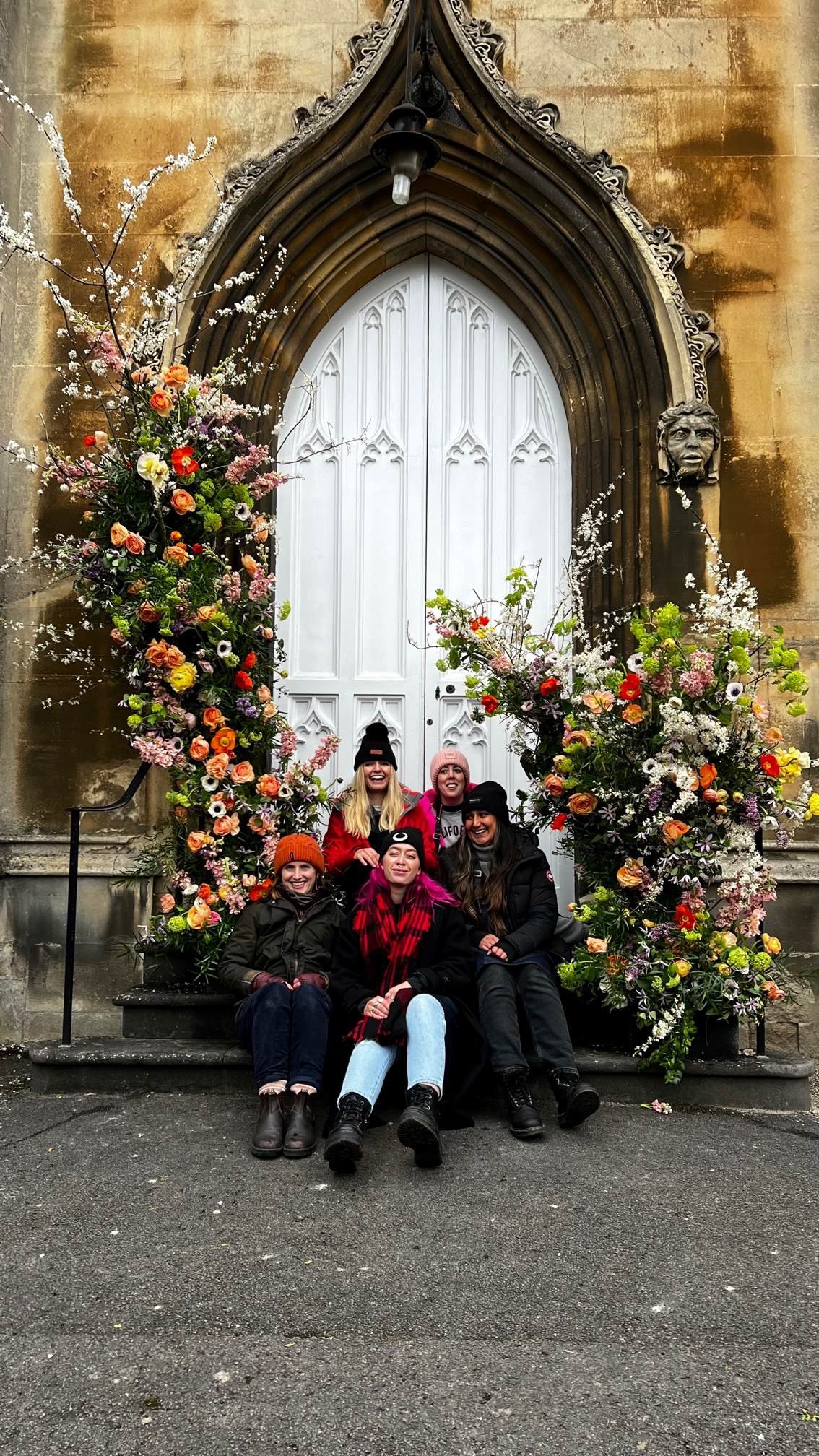 Students gathered in front of their professional floristry installation