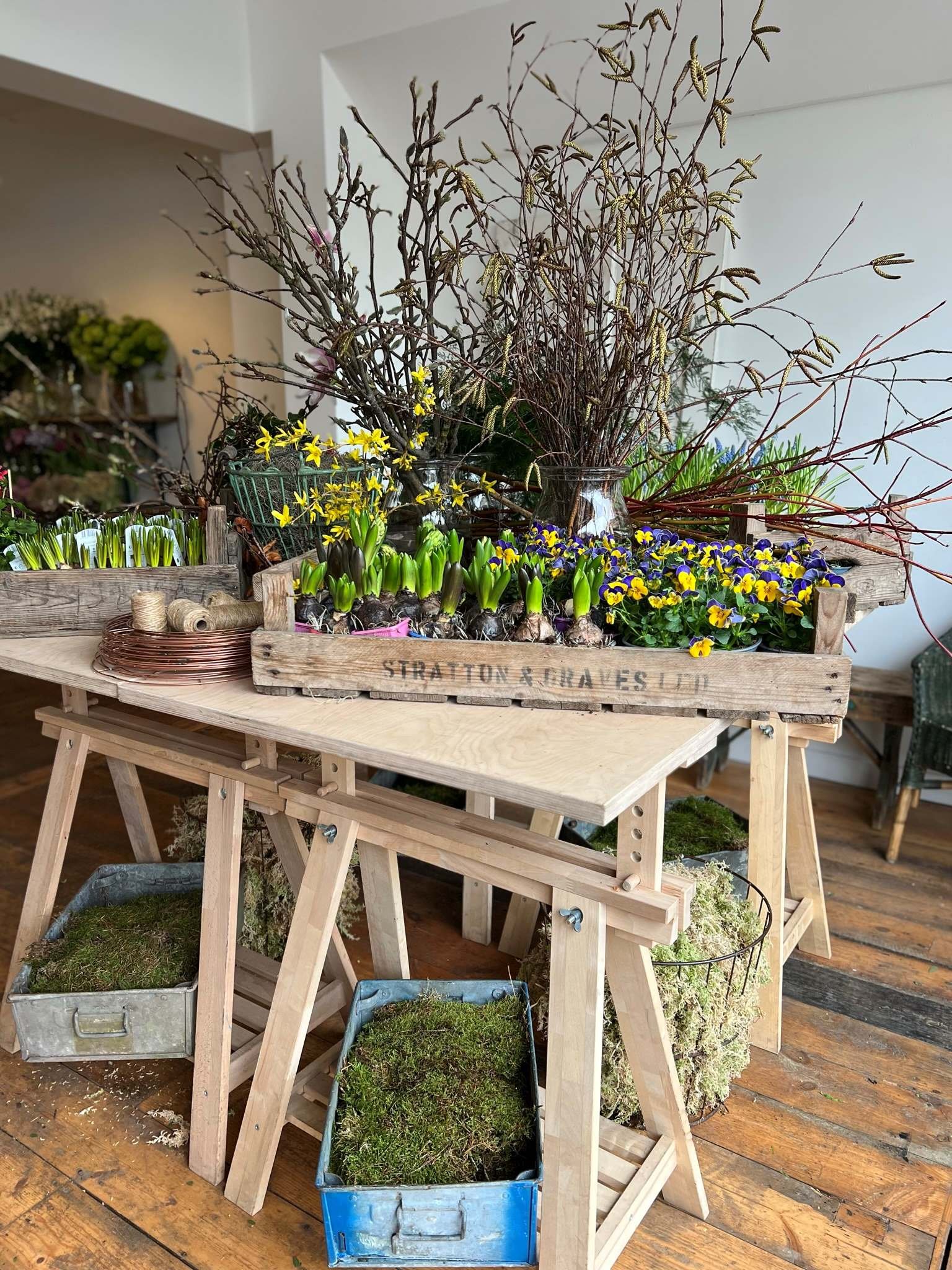 Wooden table displaying spring for Bath's Hello Spring course