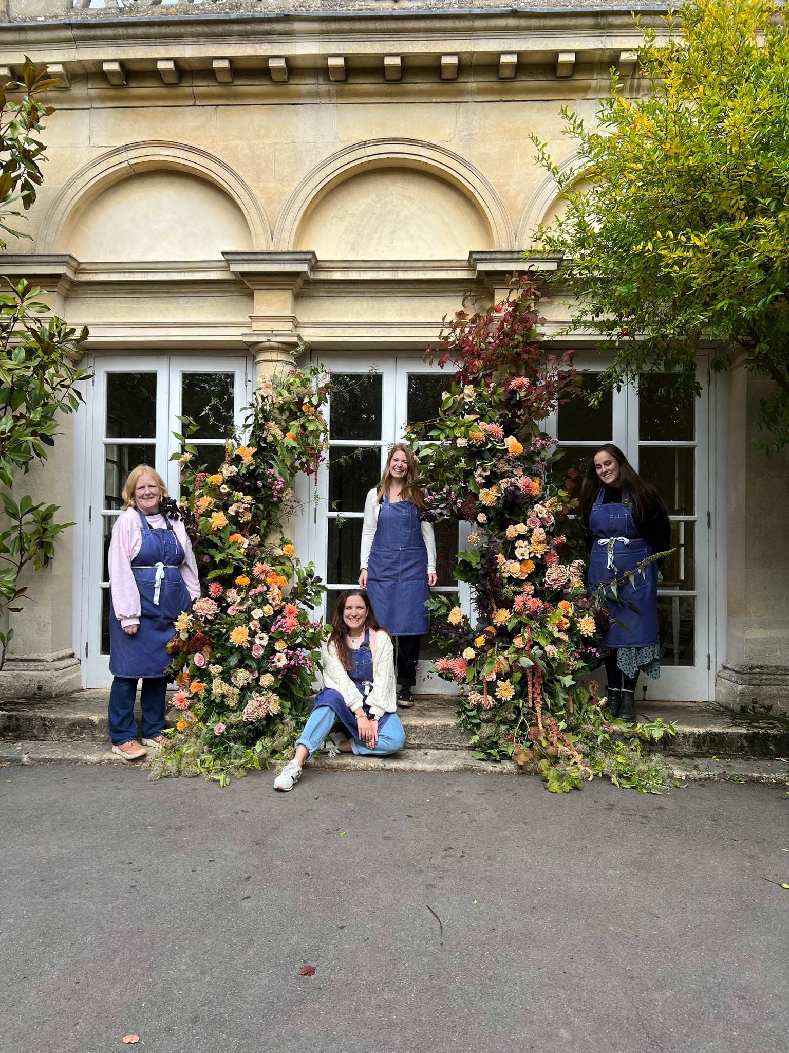 Wedding flowers course students in front of their floral installation