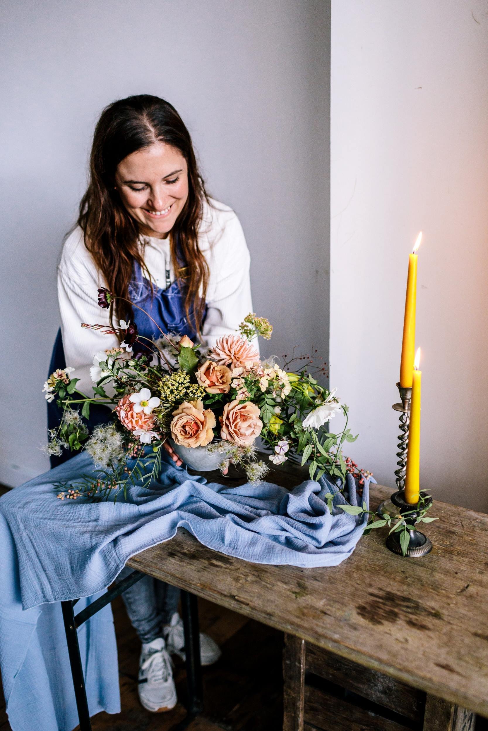 Student styling her wedding flowers table