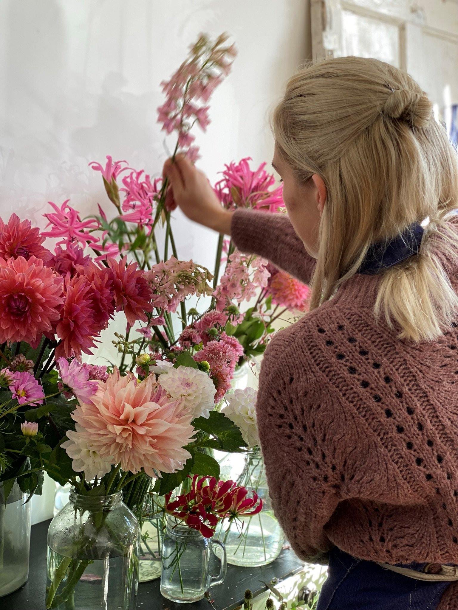 The Bath Flower School floristry basics course student selecting flowers from the flower stand