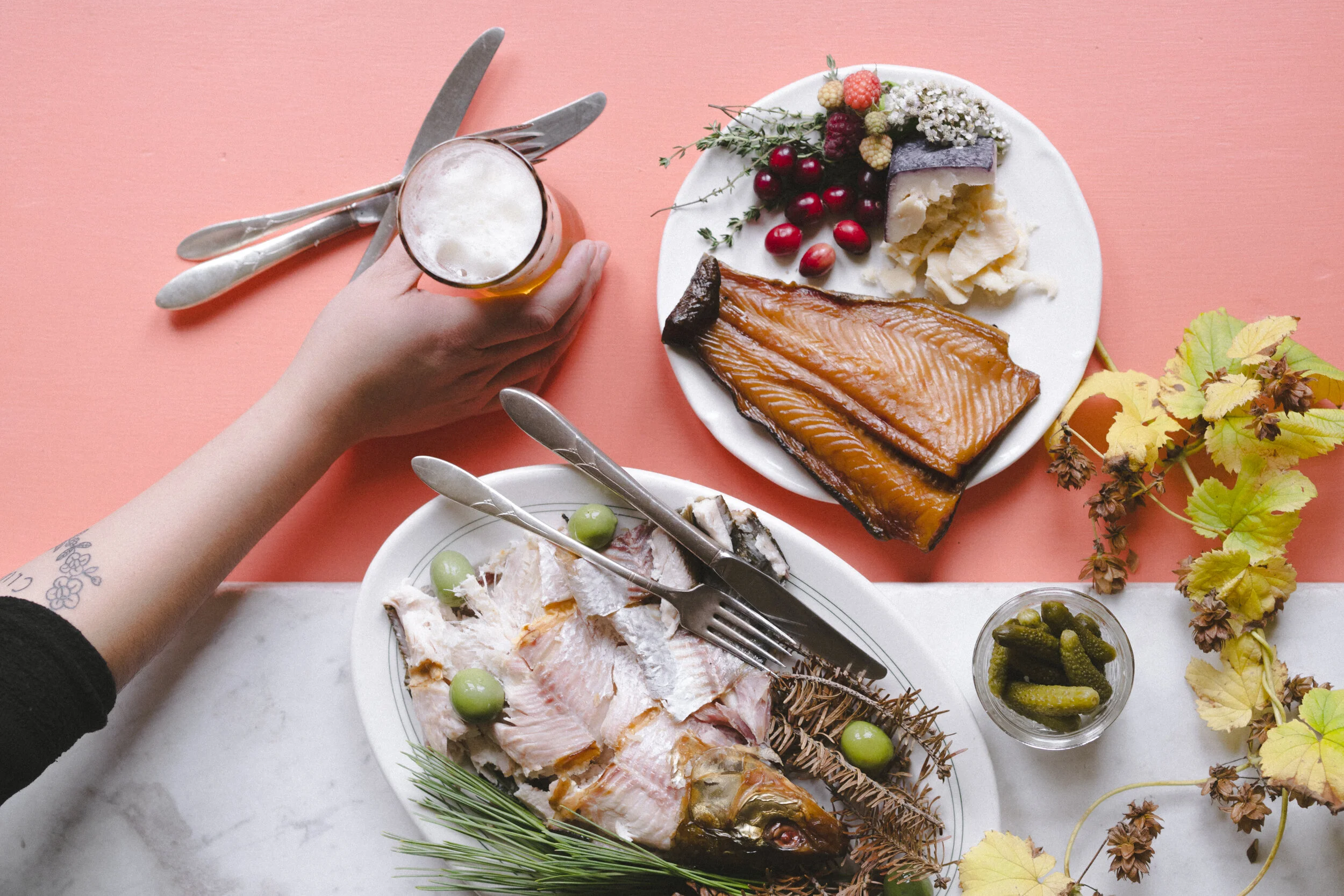 Artistic shot: platters with whitefish and lake trout served with beer