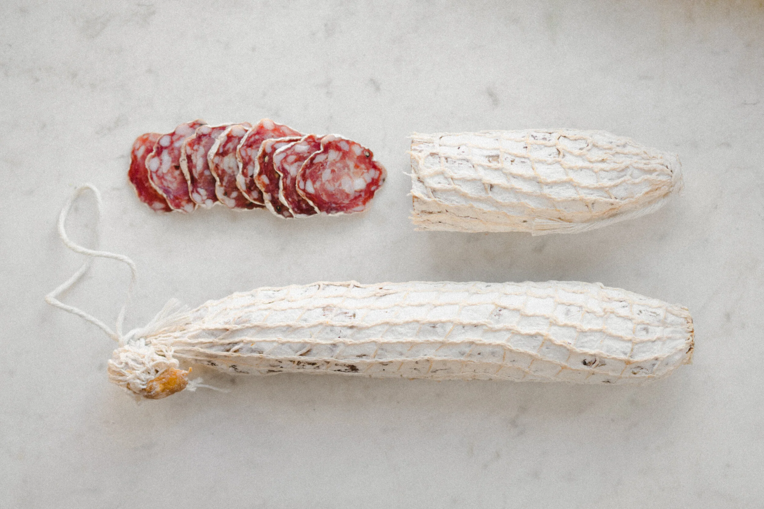 Two Sticks of Saucisson, one Partially Sliced