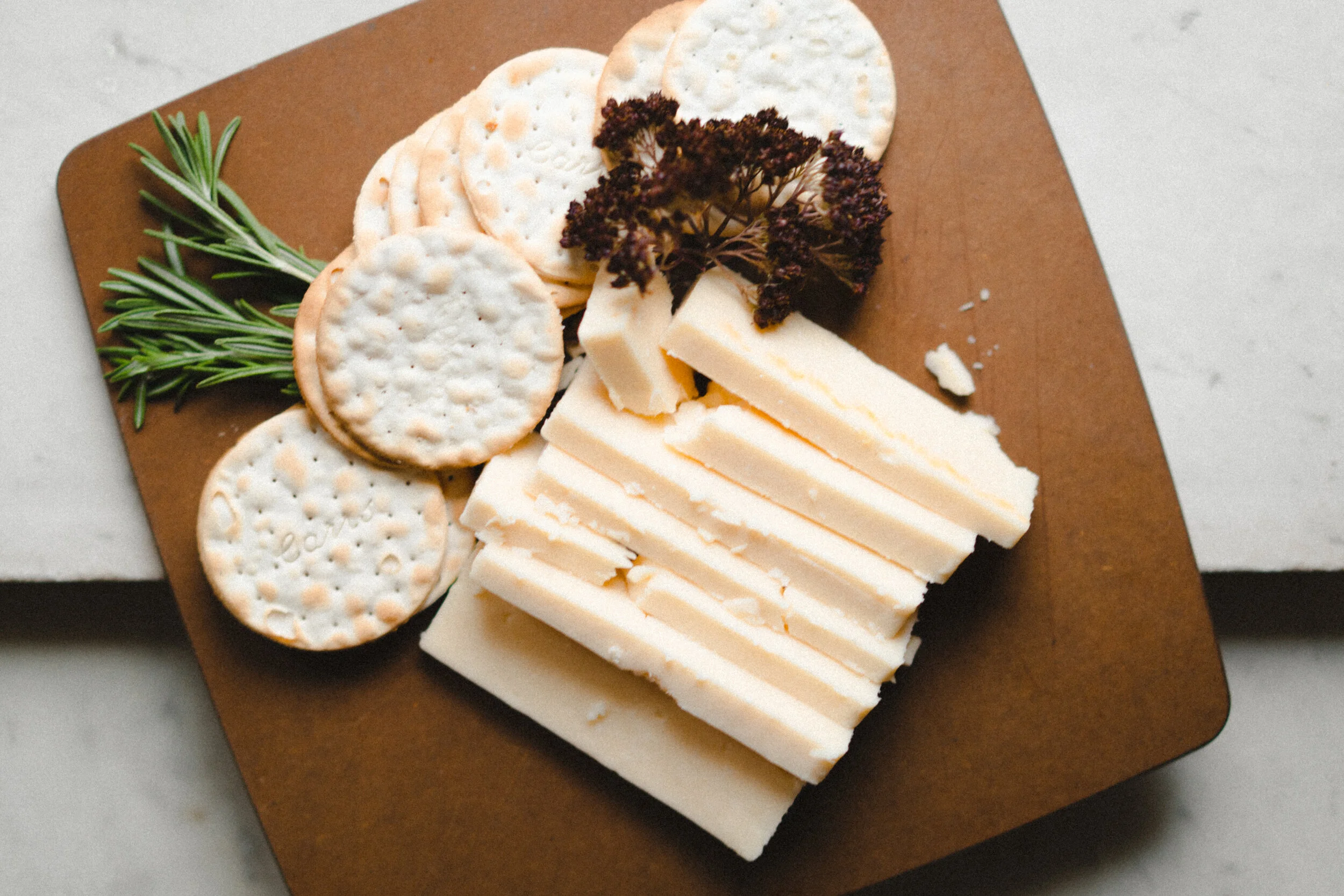 Cutting Board with Water Crackers and Sliced Cheese