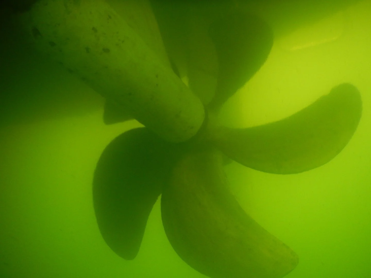 Close-up view of boat propeller underwater.