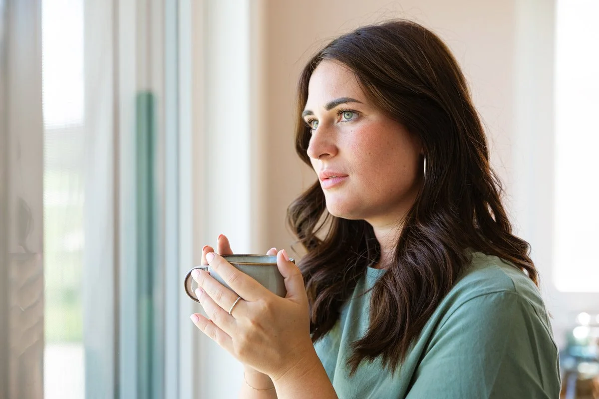 Is your nervous system the reason you are experiencing weight loss resistance? Woman drinking tea contemplating this question.