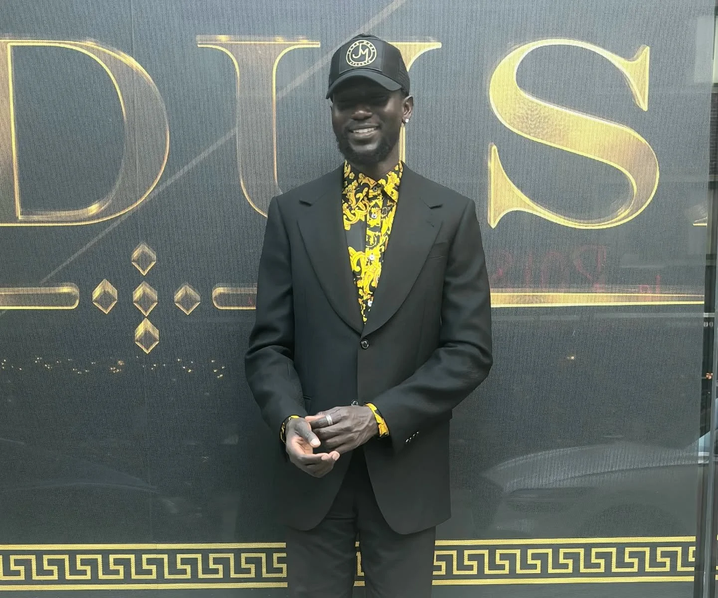 Black and gold trucker hat, black single breasted blazer by JMC