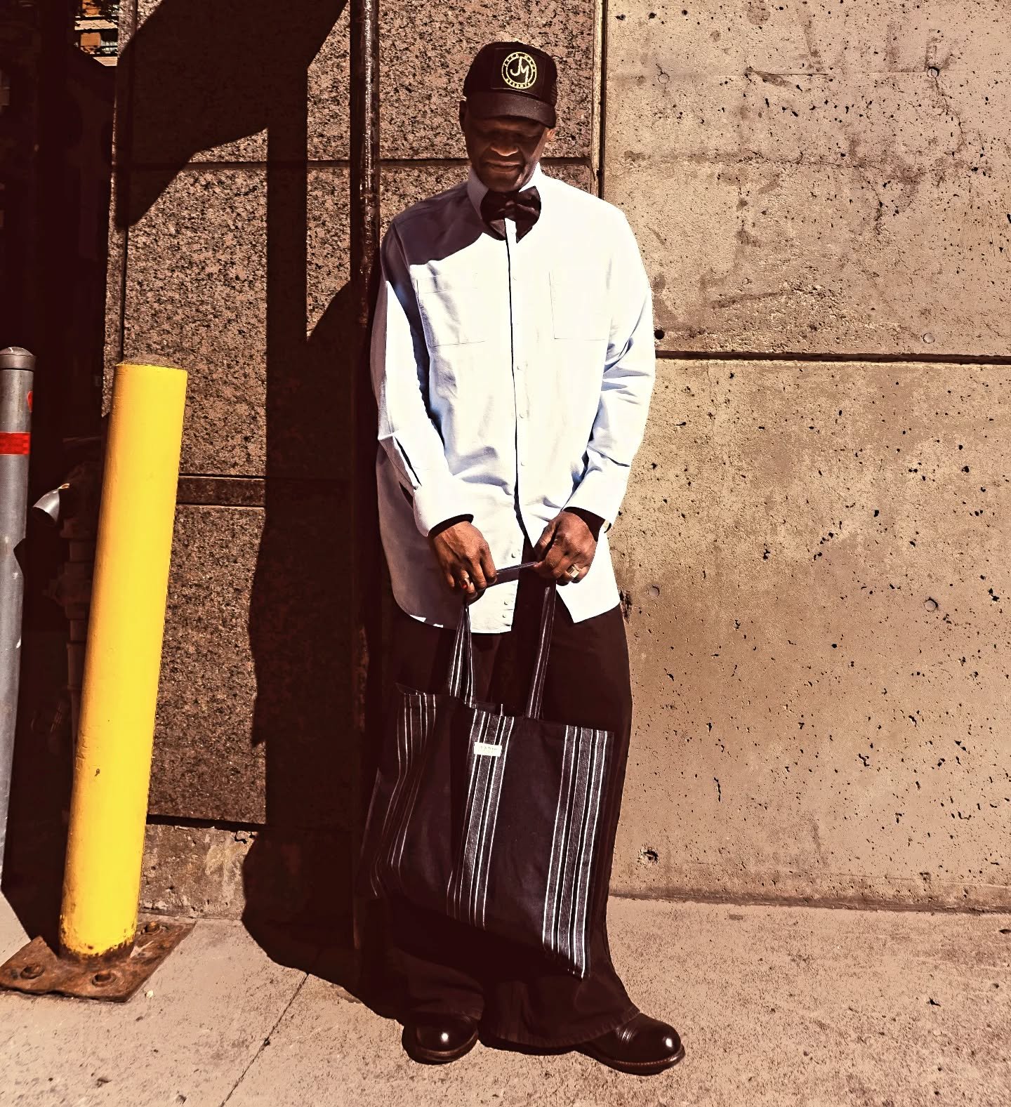 Black and gold trucker hat, light blue shirt, black bow tie and black jeans 👖 by JMC