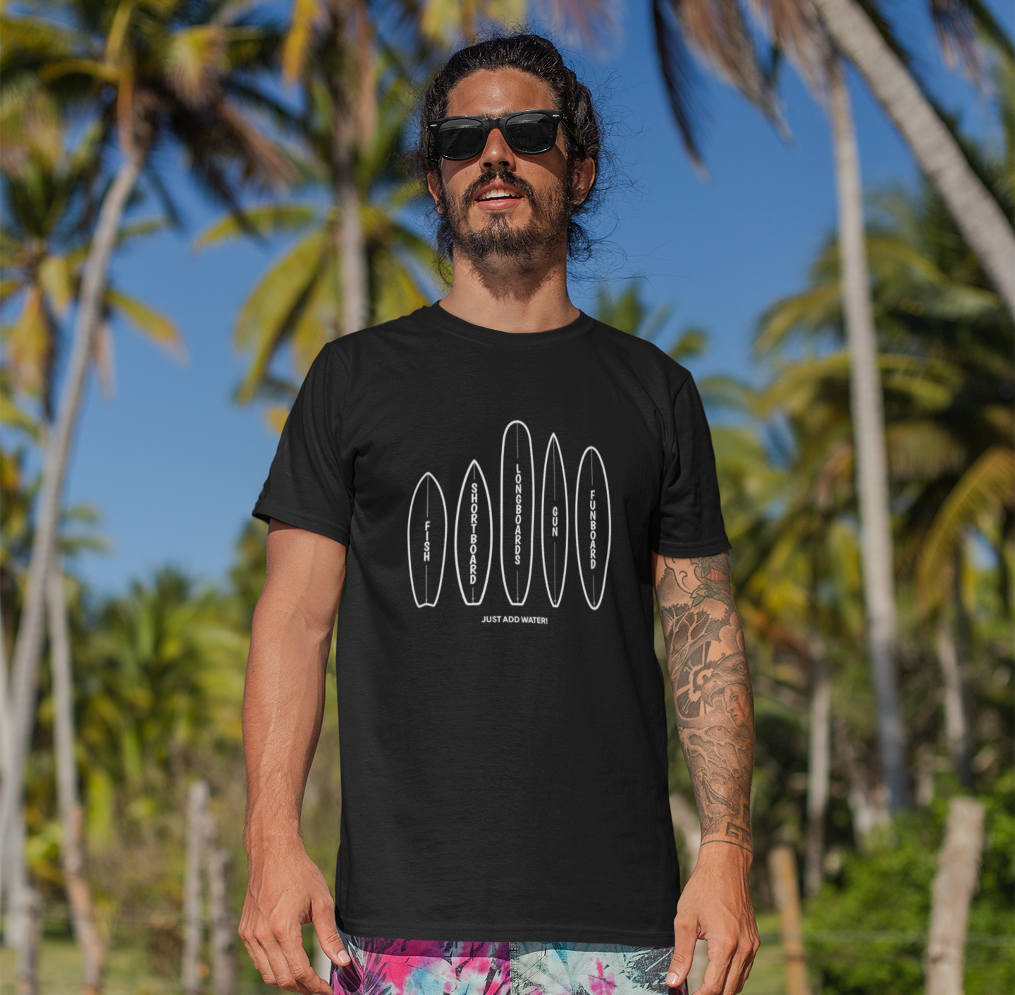 t-shirt-mockup-of-a-man-with-surfer-shorts-standing-at-the-beach-26755-2.png