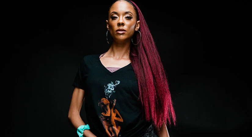 Model Jacky Reyes wearing her image on a Cannacity&nbsp;® “She’s Smokin'” shirt. Photo Courtesy of: Greg Doherty for The Artists Project and Getty Images