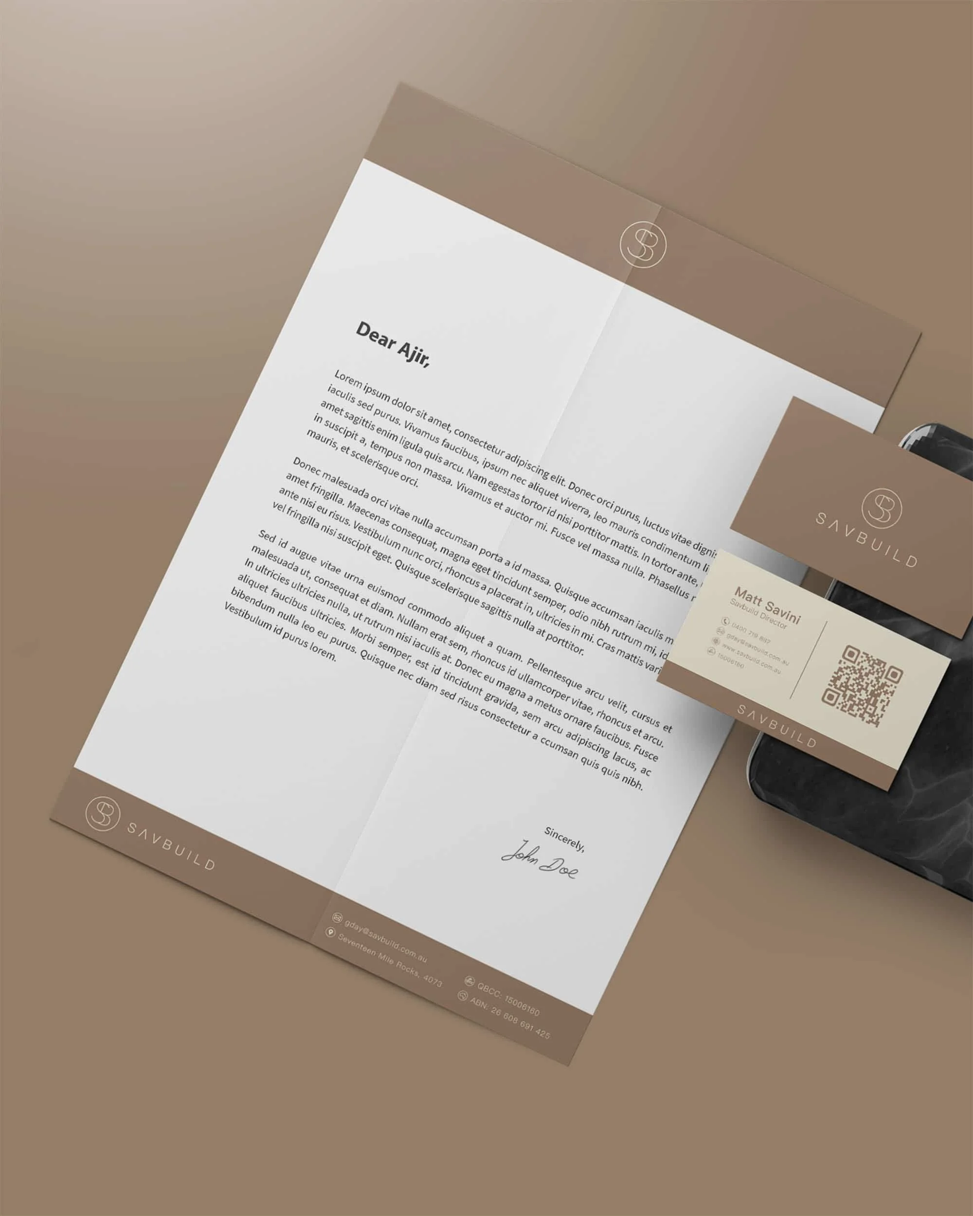 Letter from SAVBUILD with contact info and signature, placed on a beige background, with a business card and a large envelope also featuring SAVBUILD's logo.