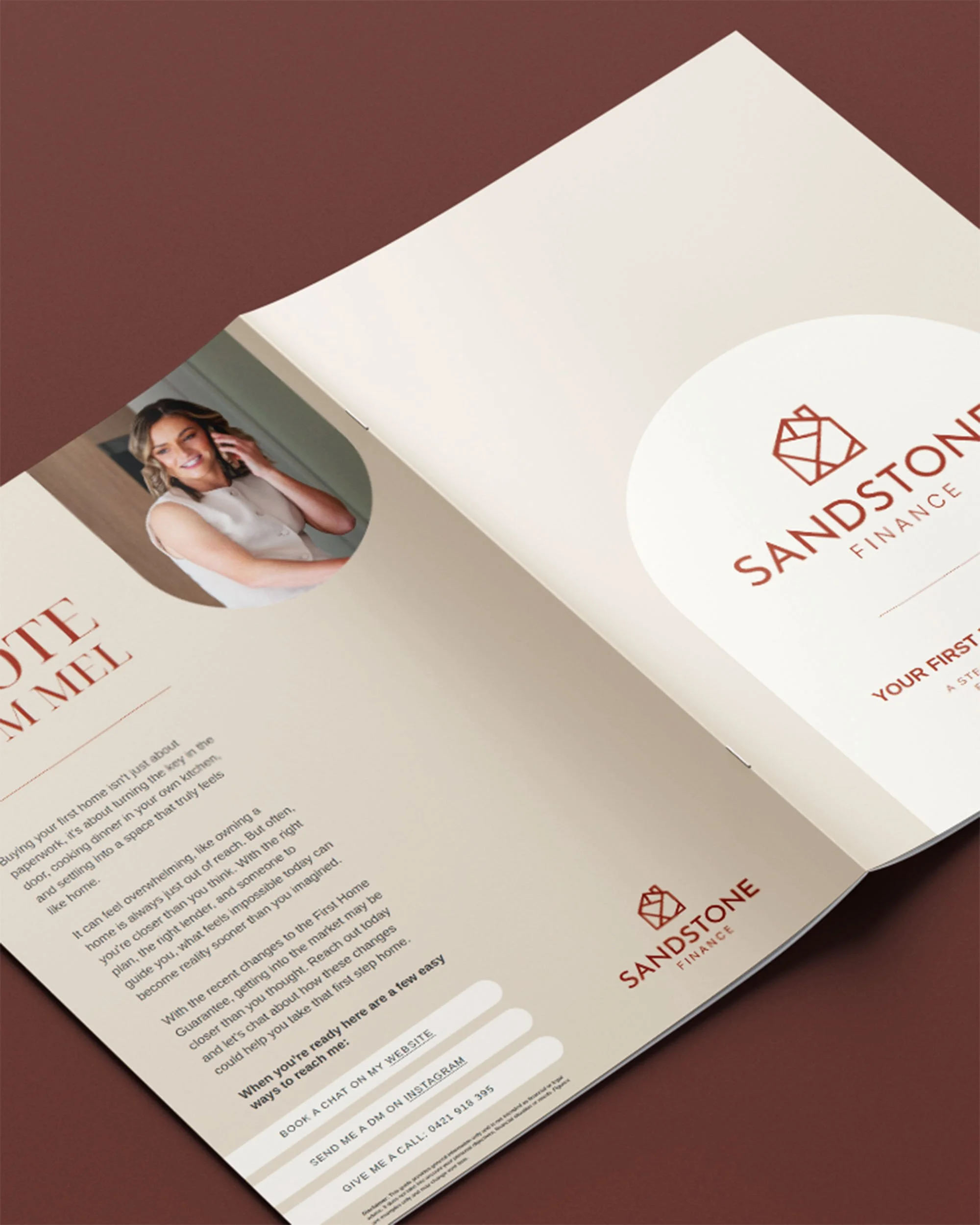 Open brochure with Sandstone Finance logo, a photo of a smiling woman, and contact information on a dark brown surface.