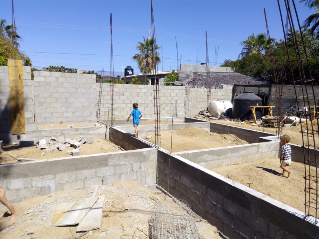 child walking on house in construction