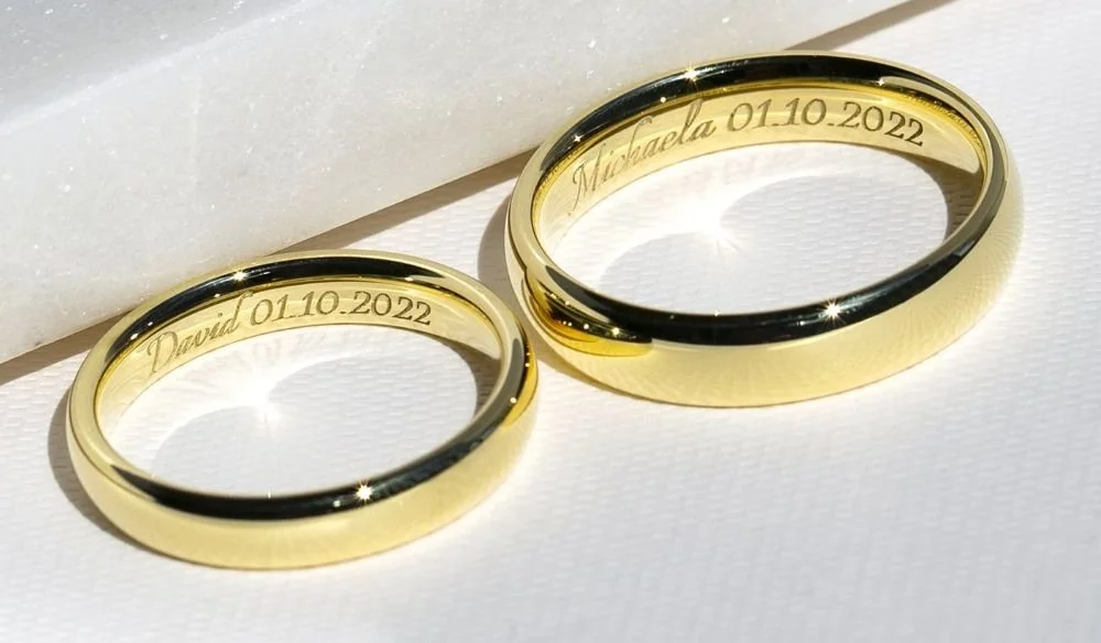 Rounded edge gold wedding band set engraved with names and wedding date Buffalo NY