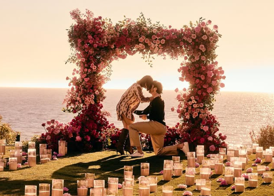 Beautiful sunset proposal with flower covered arch and candles Josh Allen and Hailee Steinfeld