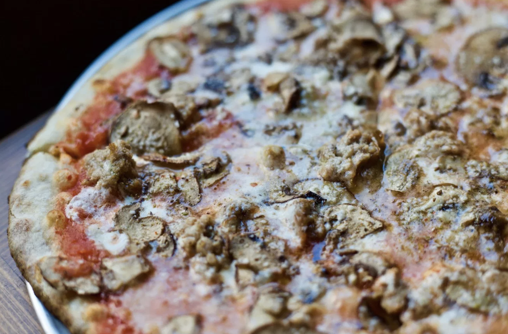 Razor-thin slices of creminis, and micro-pockets of sausage grease bubbling.