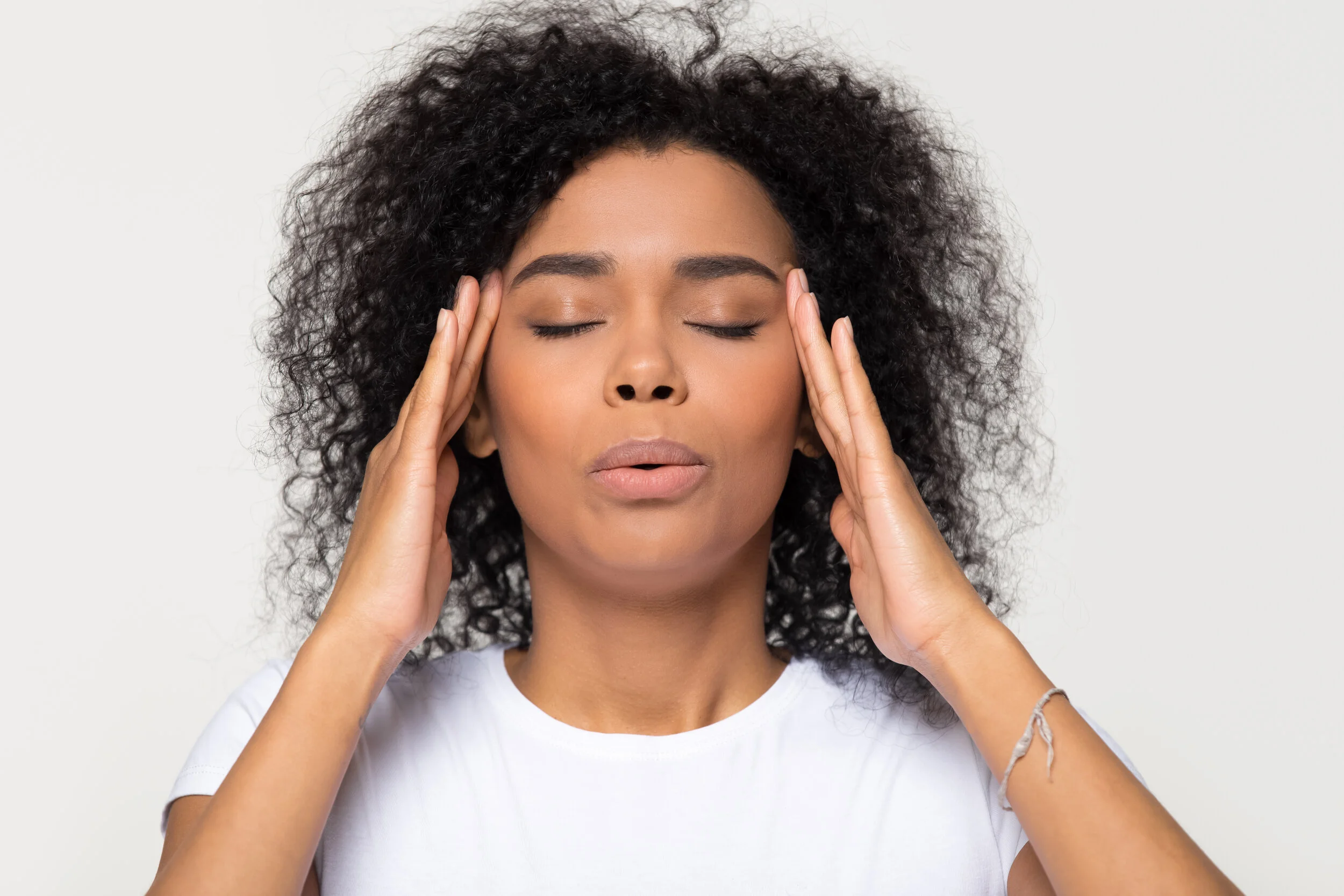 picture of woman blowing out and rubbing temples.jpg