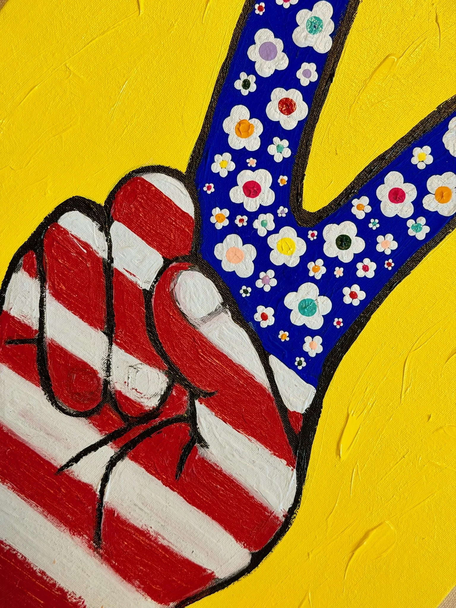 Original Peace, With Meaning painting featuring a red, white and blue hand making a peace sign, with white flowers across the blue fingers on a bright yellow background by SUPERBLOOM americana art.