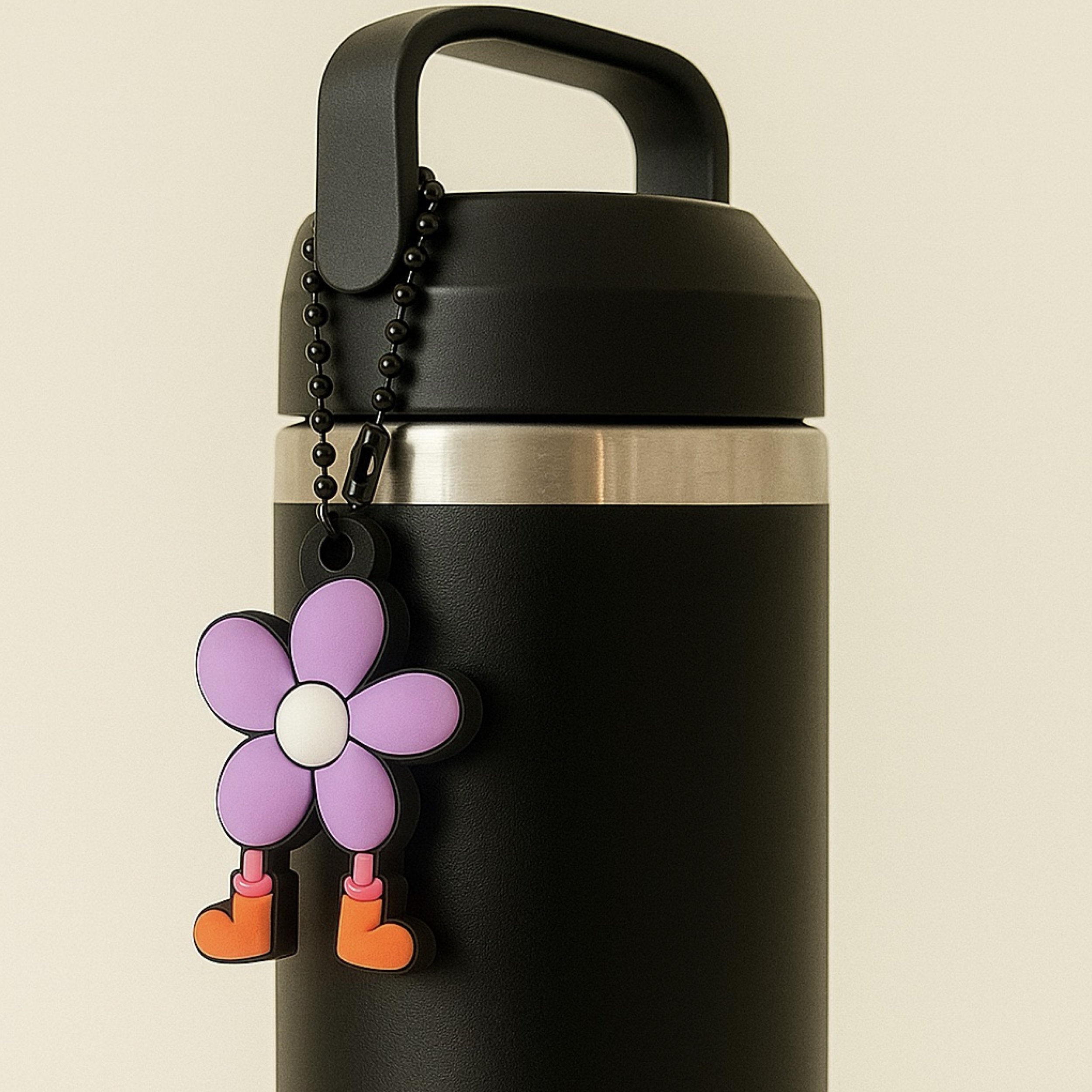 SUPERBLOOM’s Dandy Bloomer keychain clipped to a black water bottle, used as a colorful charm accessory for travel, school, or the gym.