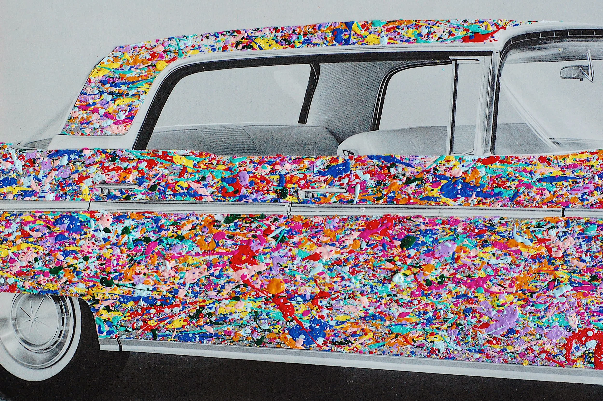1960 Lincoln Continental in a vintage black-and-white photograph, reimagined with SUPERBLOOM’s vibrant full bloom paint splatter technique across the car body.