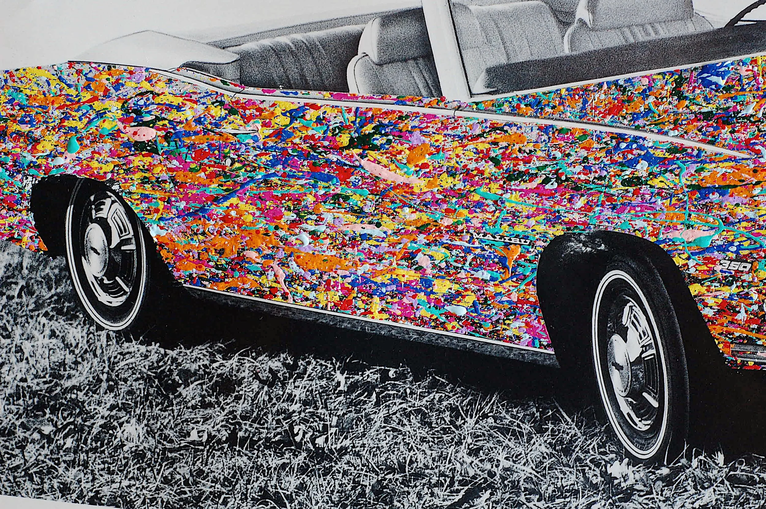 Close-up of the front grille and headlights of a 1970 Chevy Malibu convertible overlaid with vibrant multicolor paint splatter.