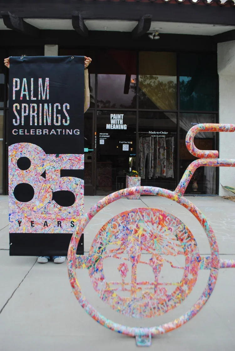 Palm Springs 85 Years banner styled in a modern hallway interior.