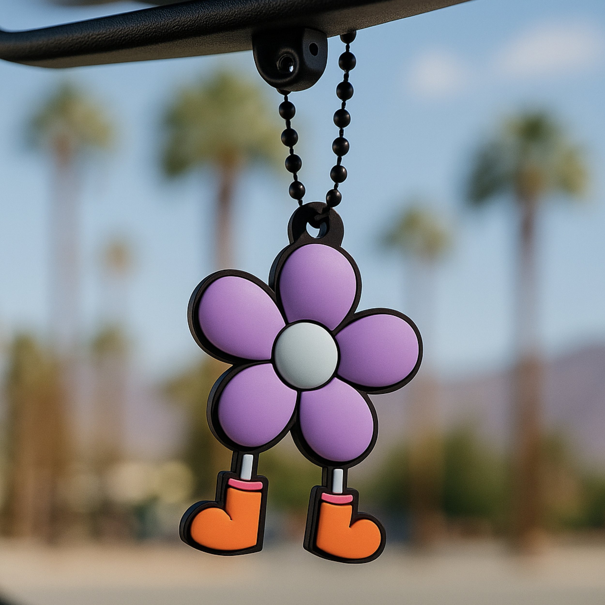 Self-Loving Lilac Dandy Bloomer keychain hanging from a rear-view mirror in Palm Springs, used as a cute car charm and travel accessory.