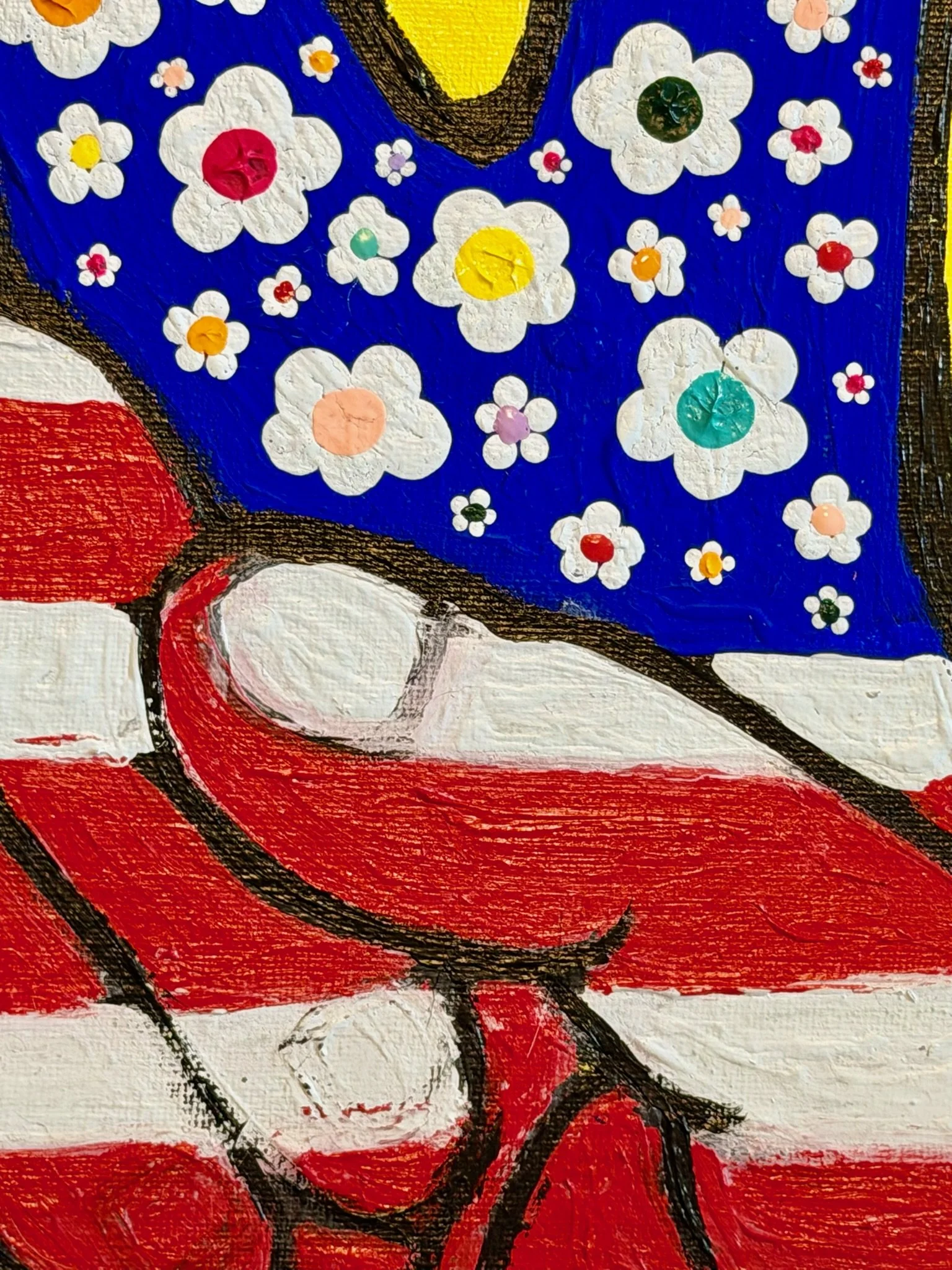 Close-up showing the textured red and white striped hand, black outlines and small painted flowers of Peace, With Meaning.