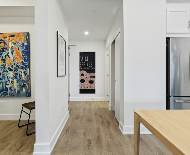 “Palm Springs 85 Years banner hanging in a contemporary office lobby space.”