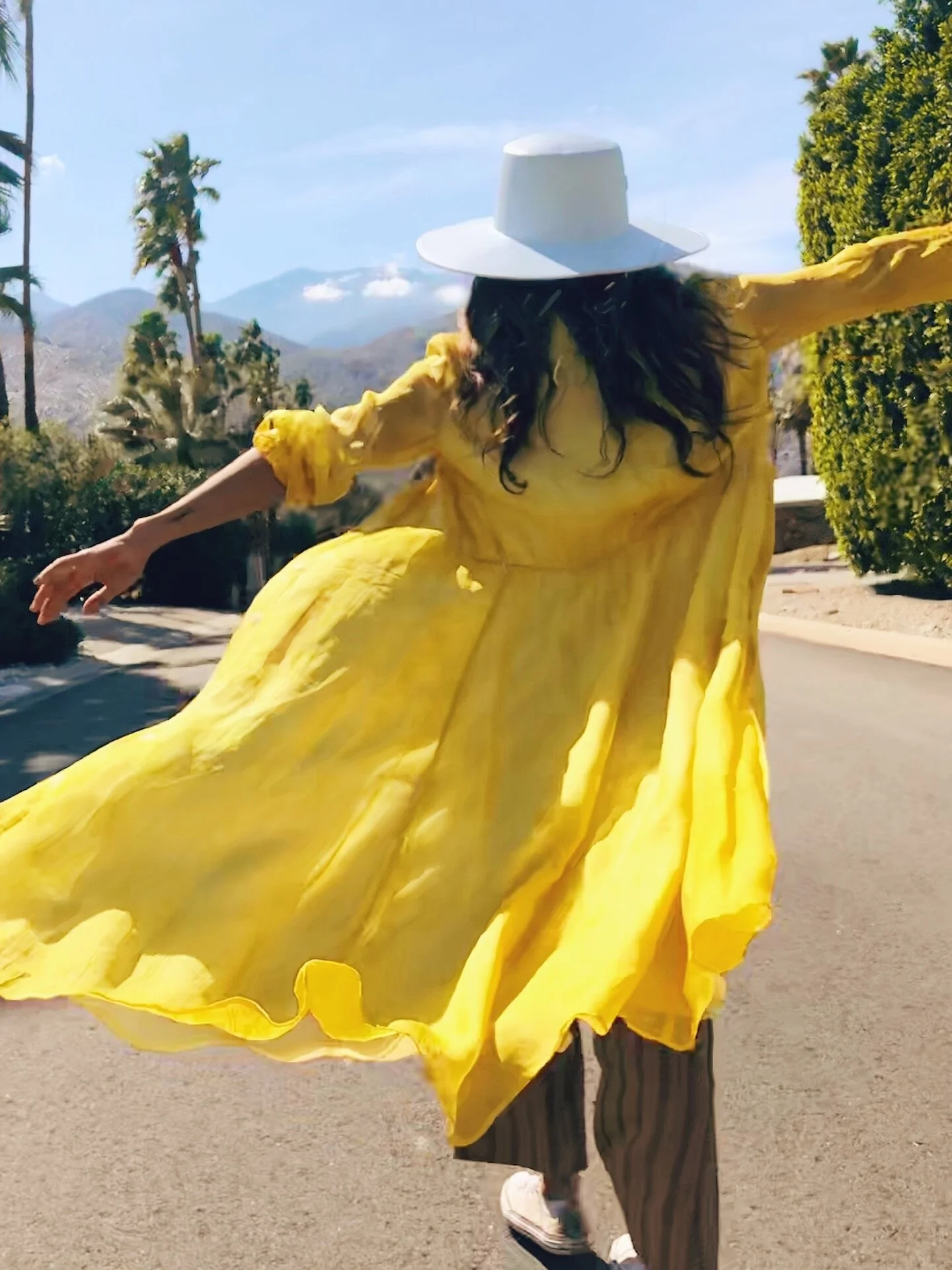 superbloom-girl-in-yellow-dress-walking-wearing-hat.JPG