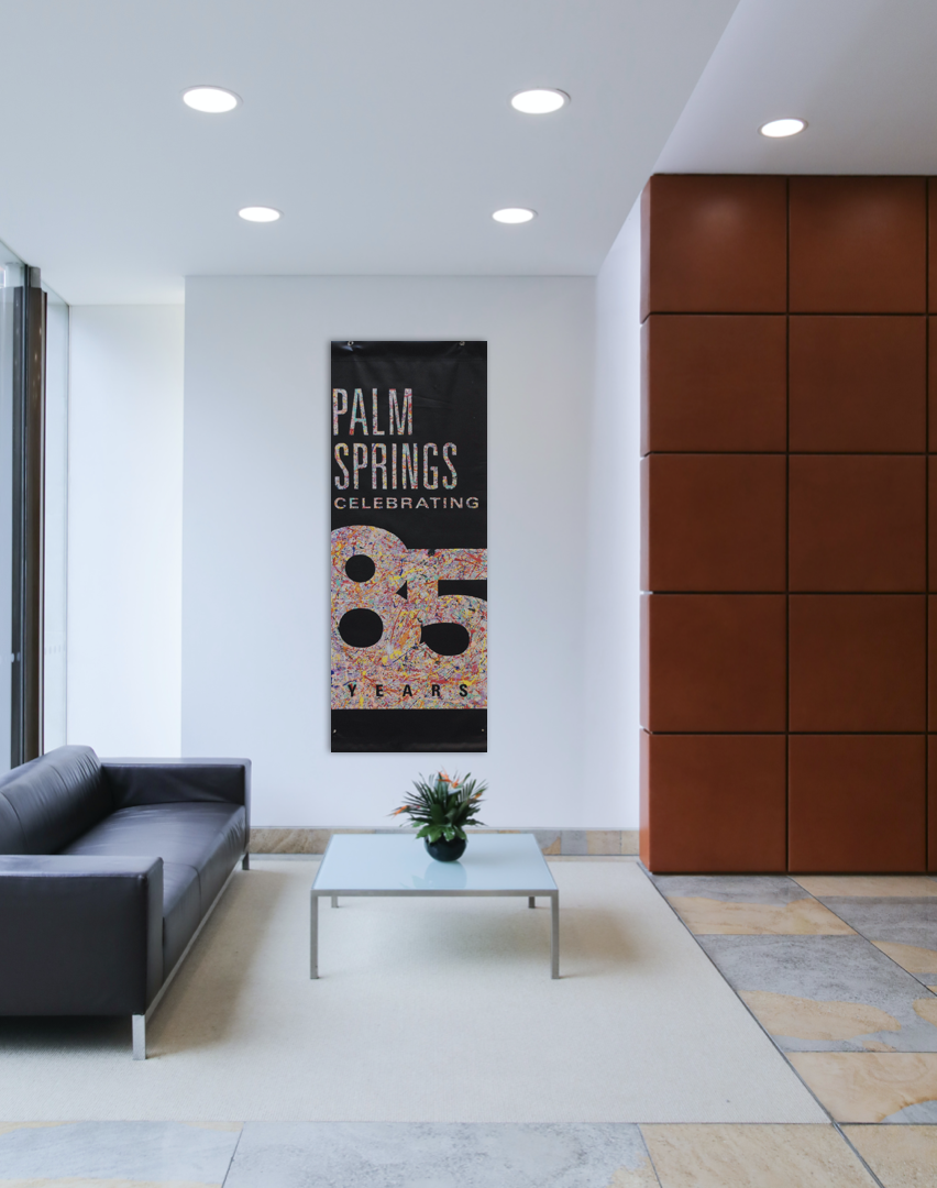 SUPERBLOOM Palm Springs 85 Years artwork — black banner with colorful 10-color splatter text on reclaimed vinyl, 63 x 23.5 inches.