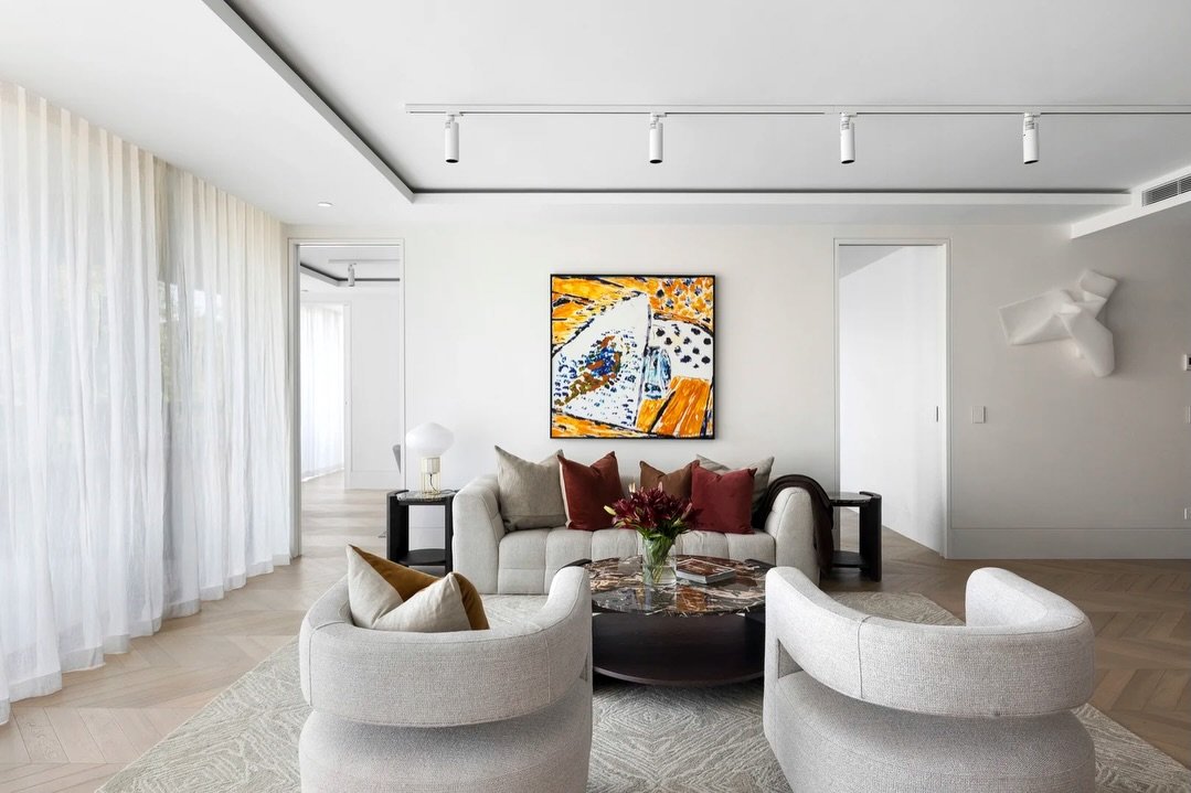 Wanting to double down on the gallery vibes of this apartment, we selected two standout pieces from @studiogallerygroup for this living room and kept furnishings completely neutral. 

Loving the contrast with *rich* cushion colours and super clean li