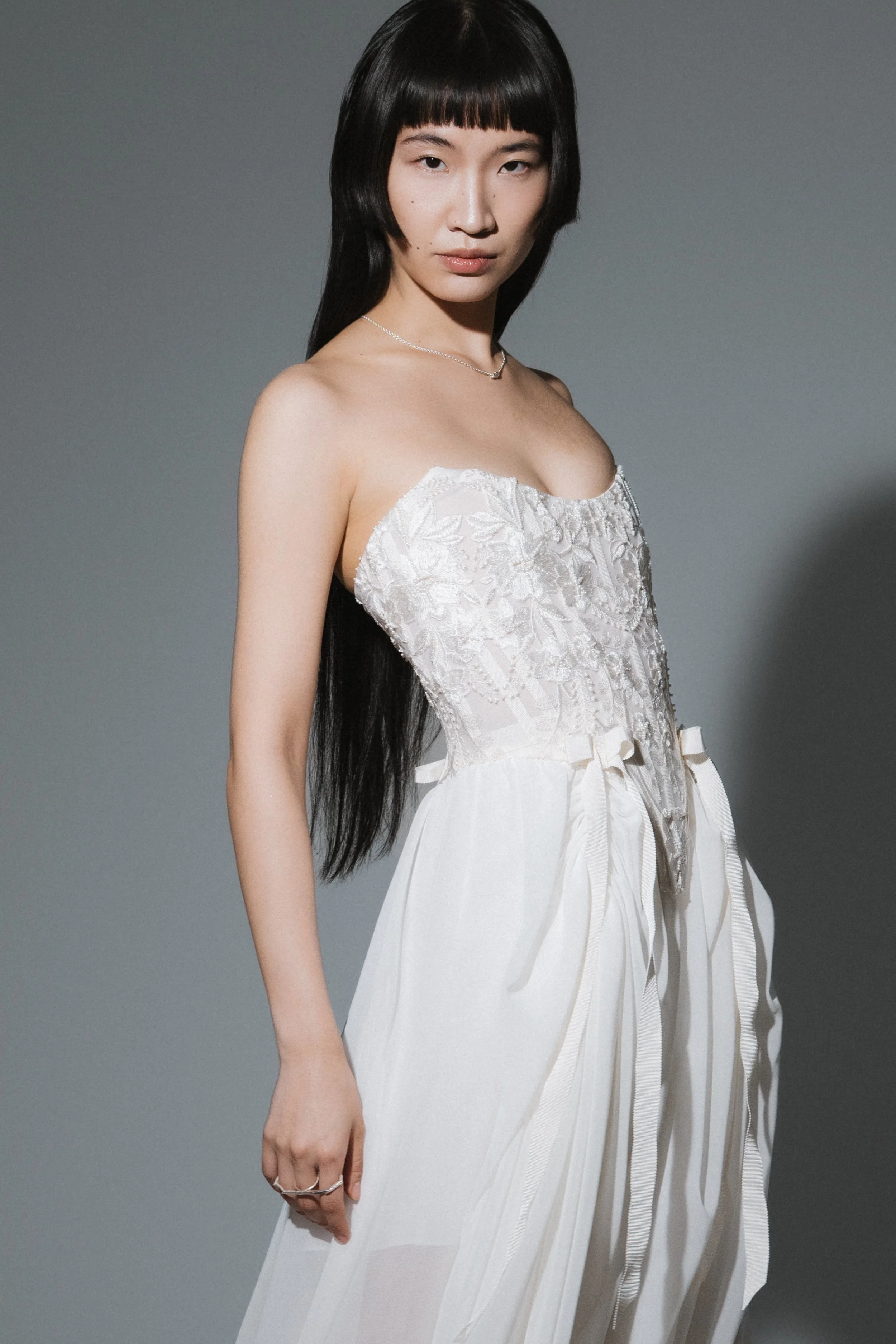 Side view of romantic bridal corset with structured waist and delicate lace texture