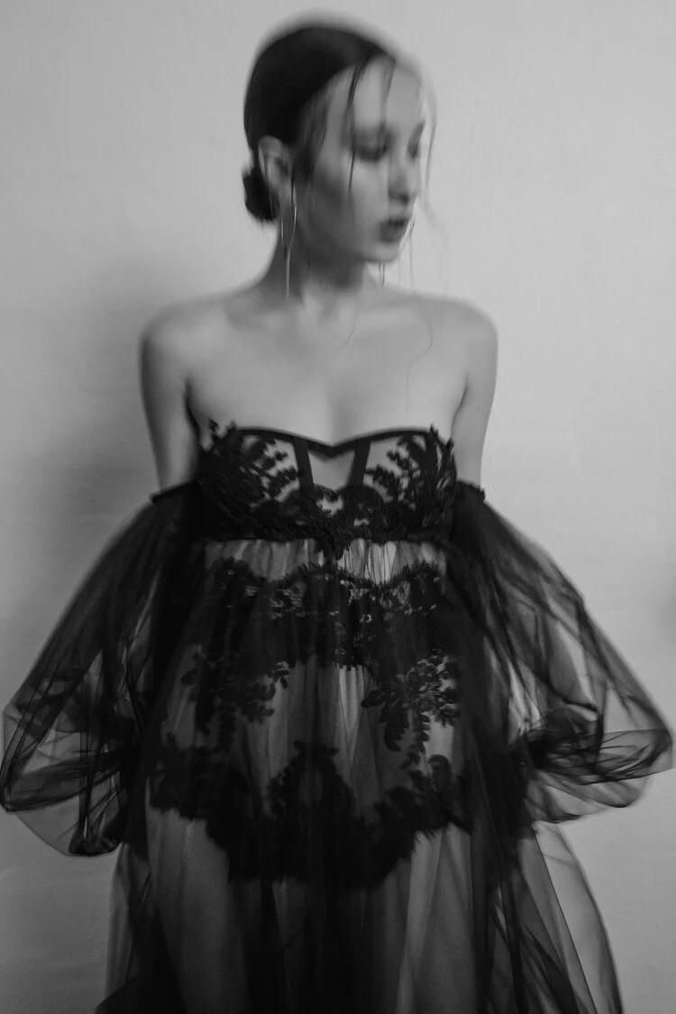 Sheer black lace couture dress with an avant-garde, transparent design