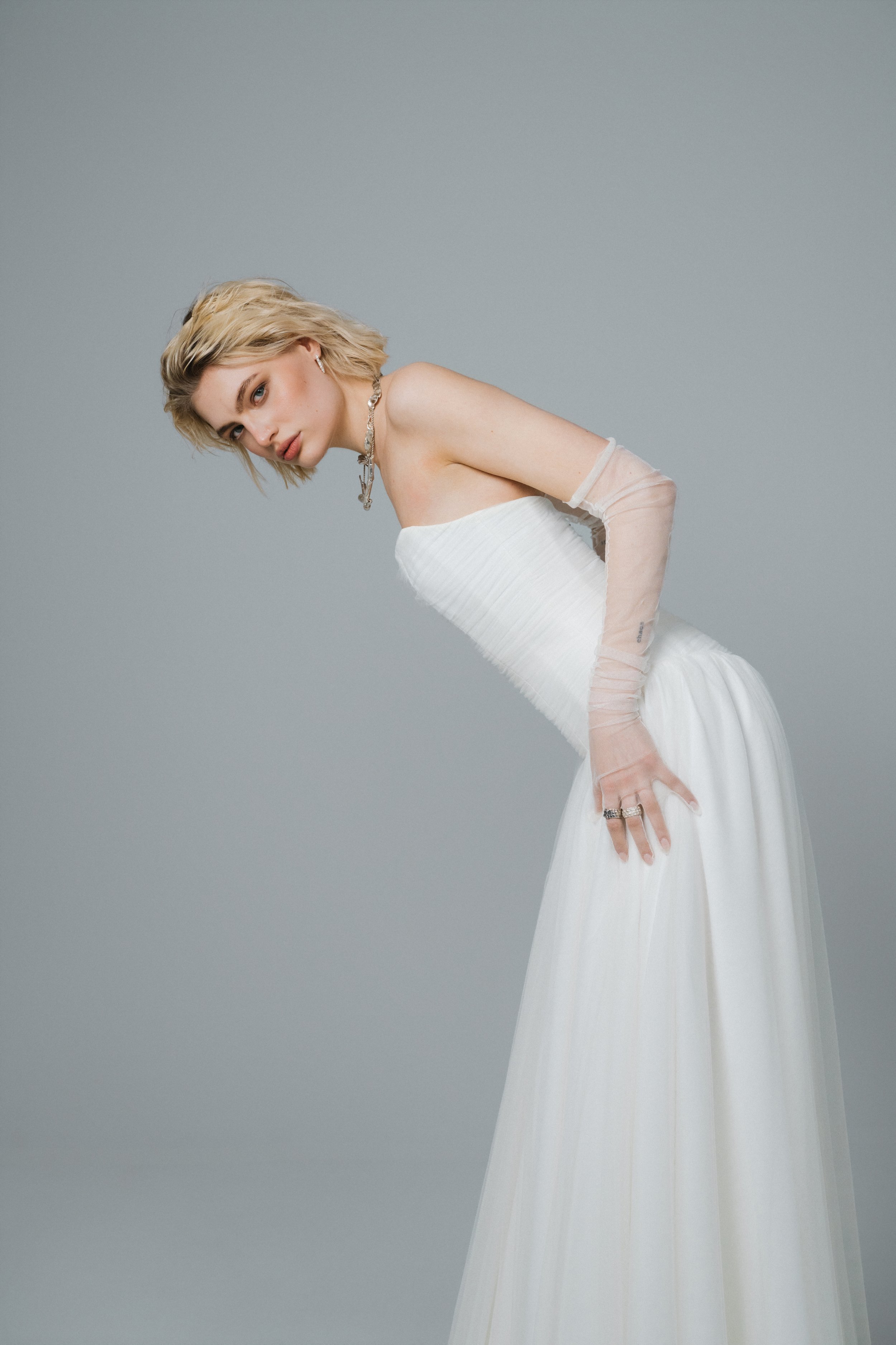 Side view of transparent ivory tulle gloves with romantic overlength ruching