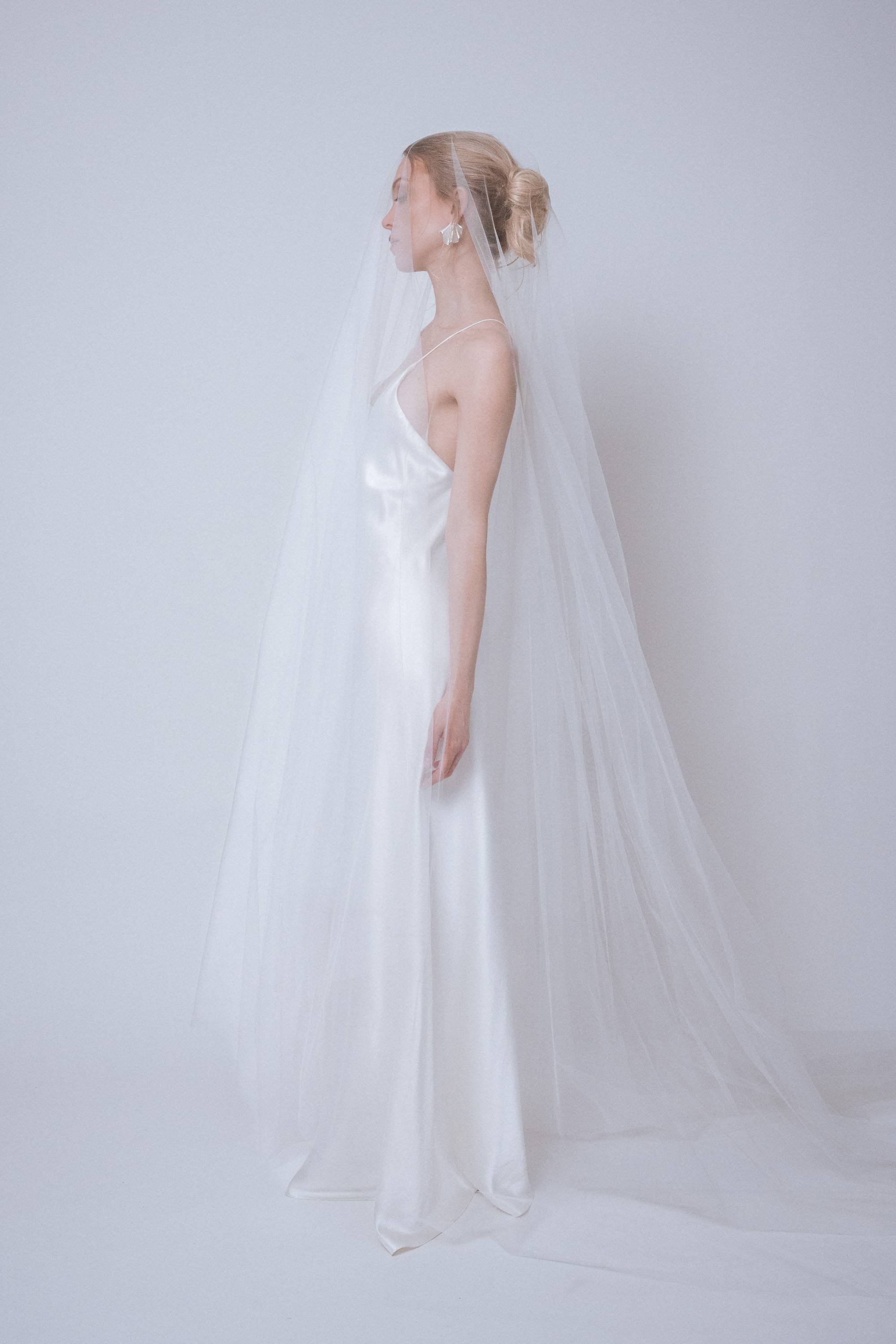Side view with blusher in front, showing rounded silhouette and dramatic tulle volume