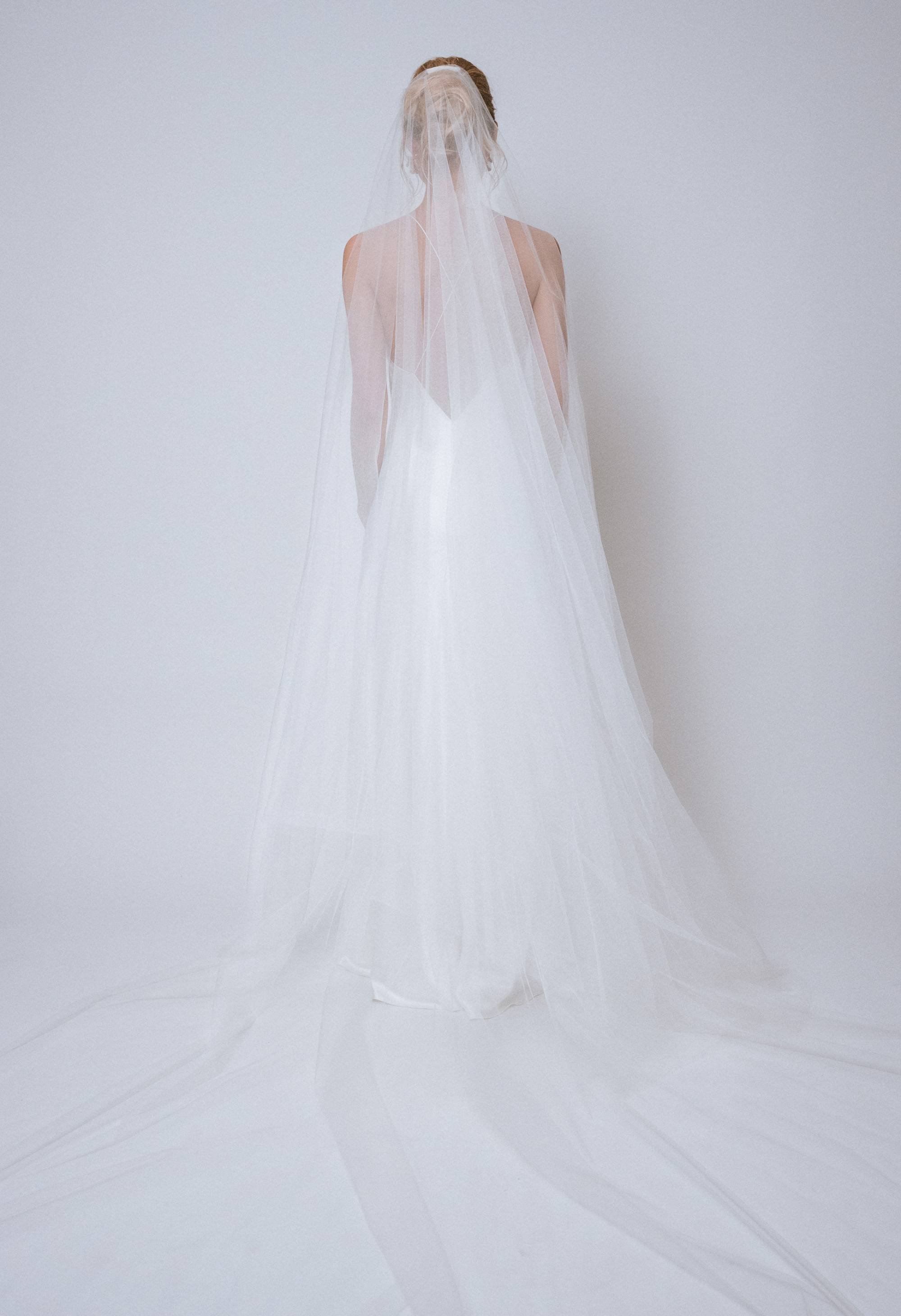 Back view with both layers flipped back, highlighting full cathedral length and cascading folds