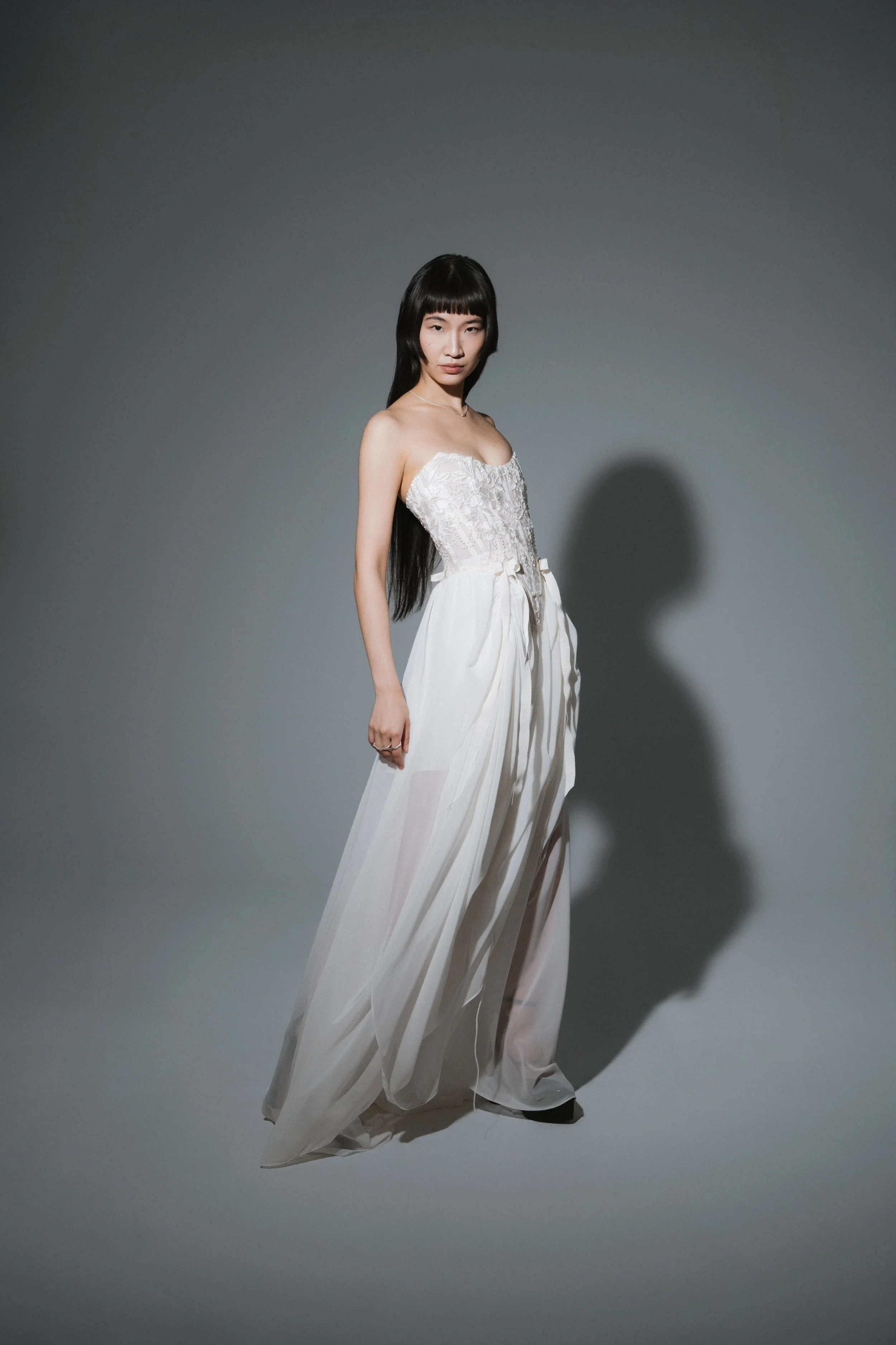 Side view of romantic floor-length chiffon wedding skirt with soft cascading silhouette
