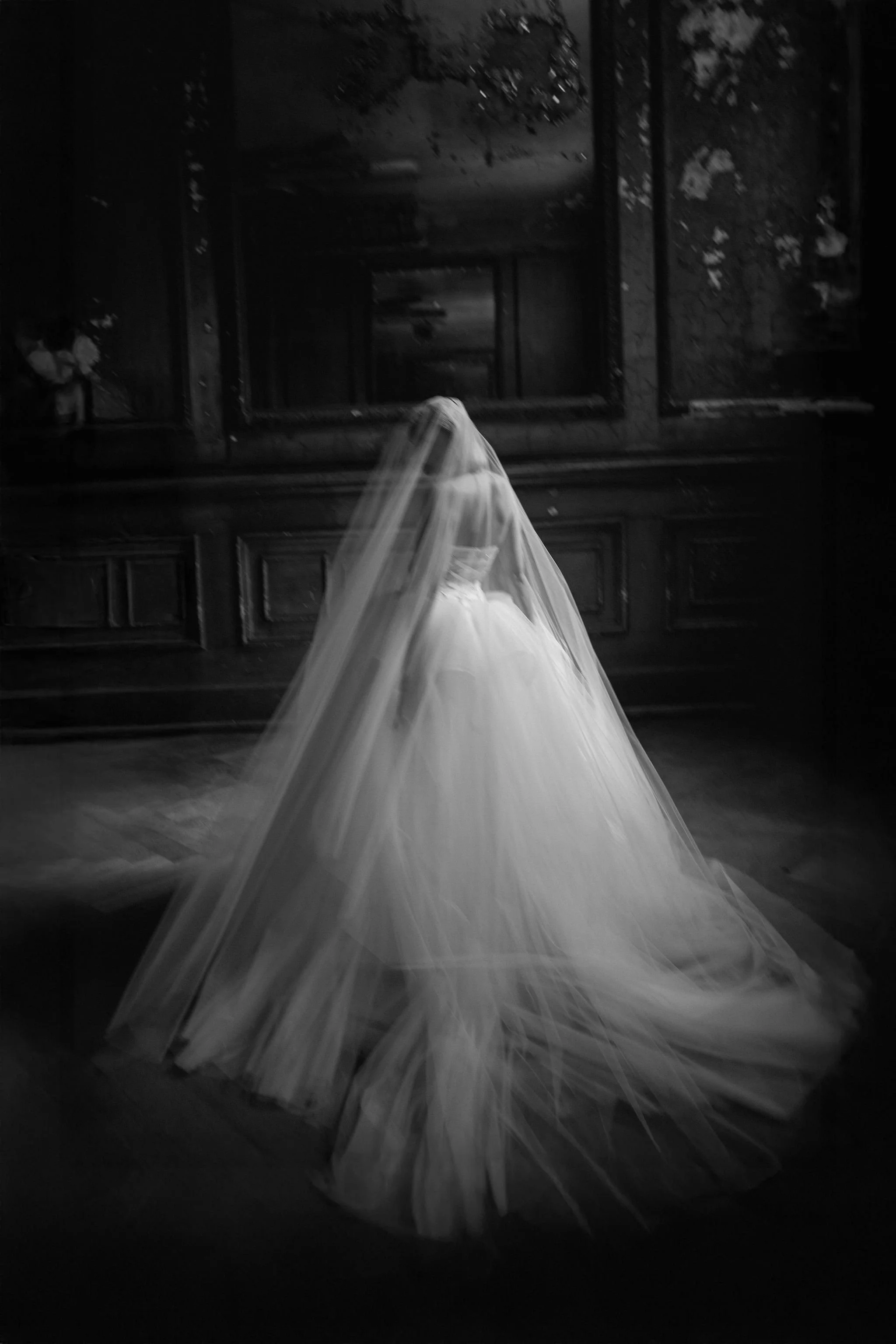 Back view of an edgy wedding dress with layered tulle creating a dramatic couture silhouette
