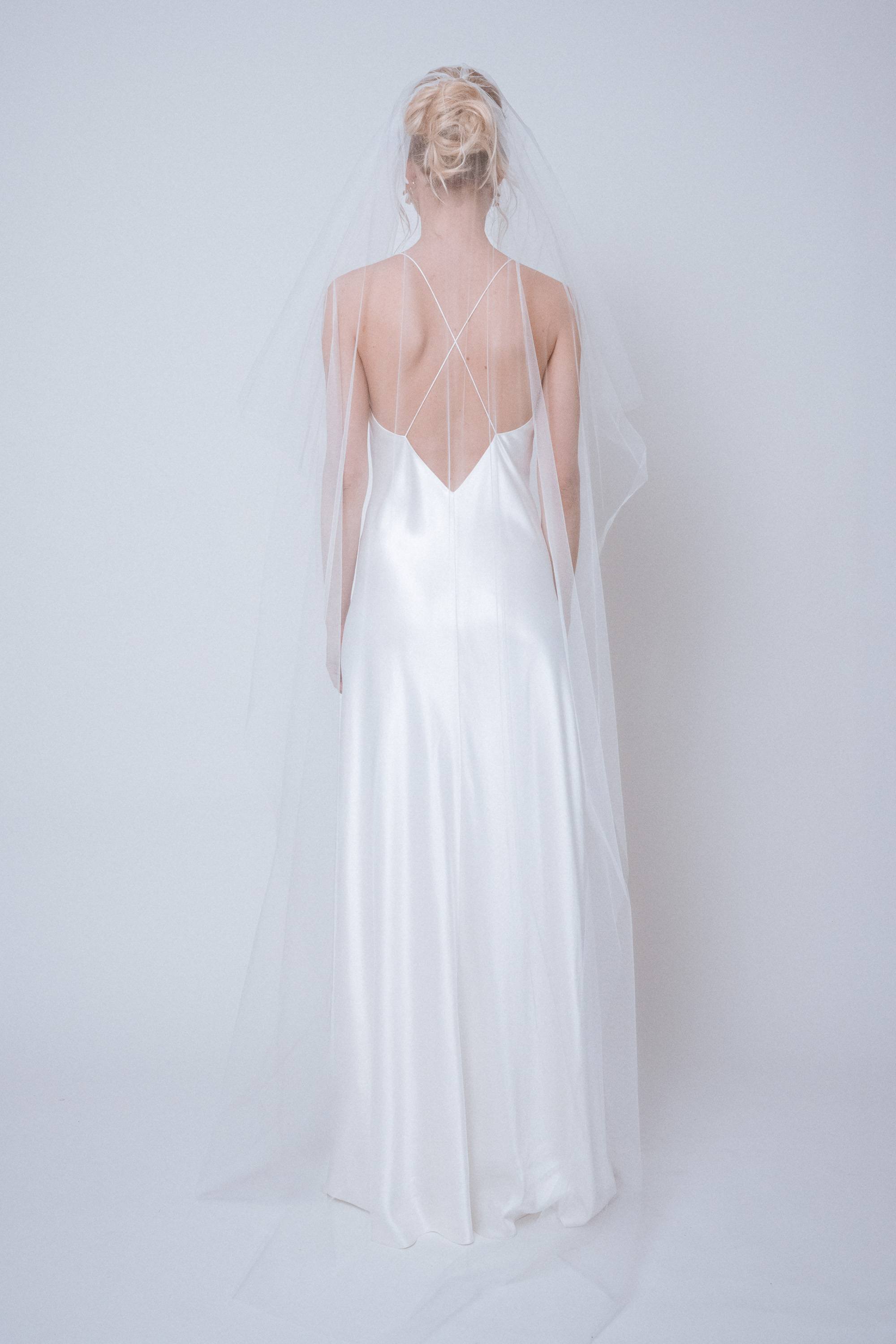 Back view of the Signature Veil with blusher layer still covering the face, highlighting the veil’s sculptural layers from behind