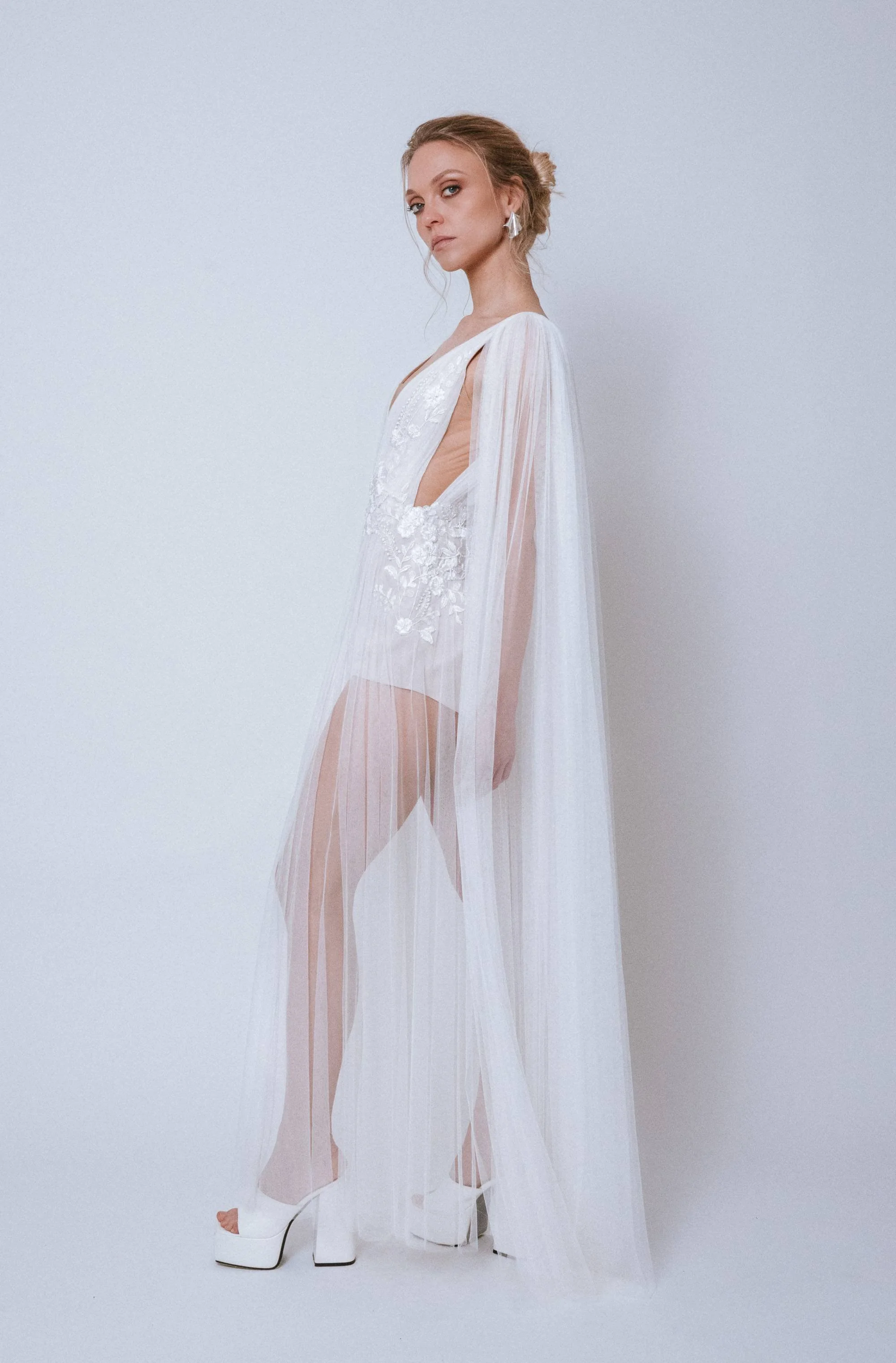 Side view of the Airy Gown with sleeves showing soft movement and layered tulle texture